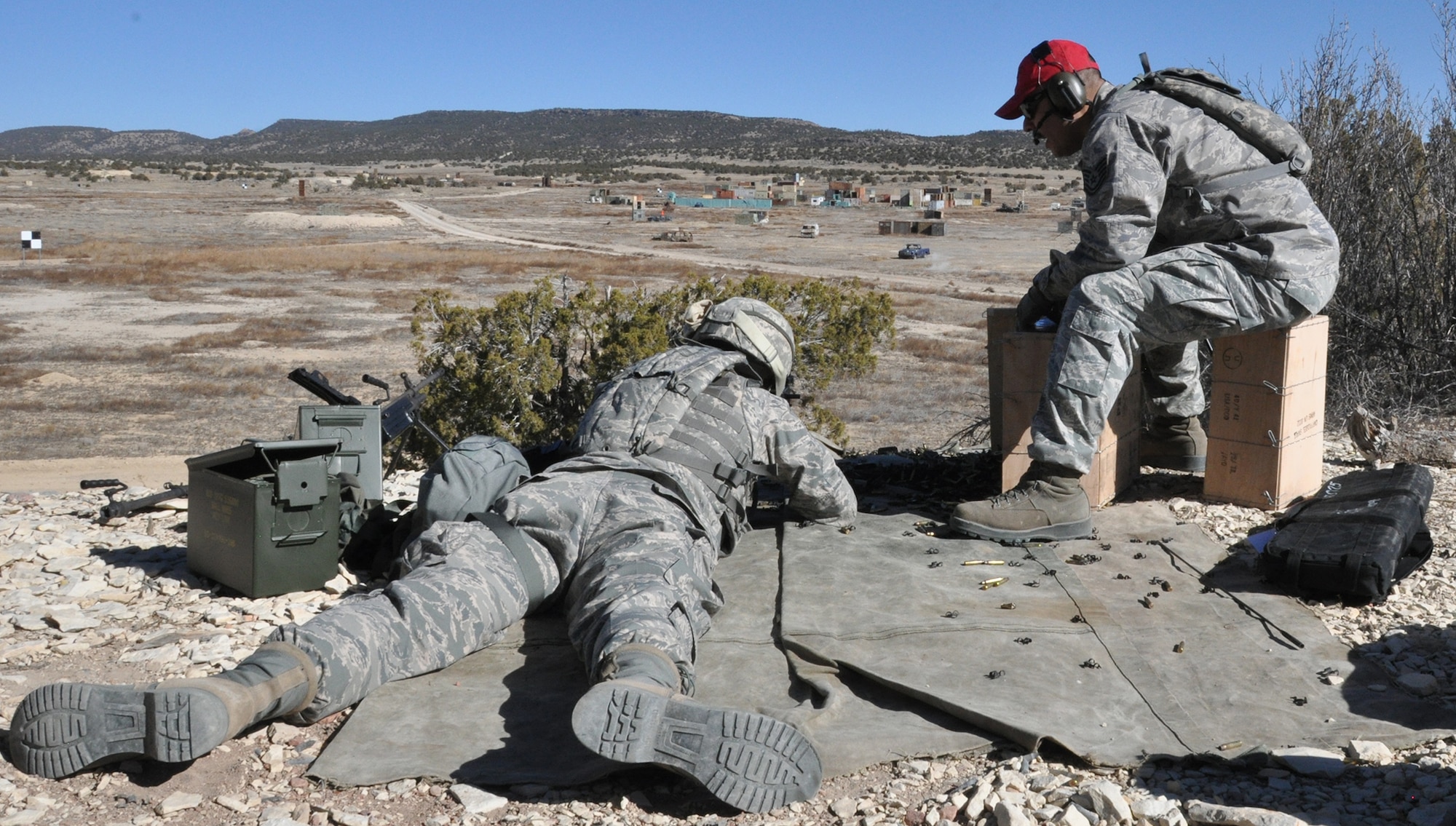 Tech. Sgt. Jose Medellin, noncommissioned officer in charge of 302nd Security Forces Squadron combat arms, right, gives instruction to Senior Airman Steven Raeburn, fire team member, on the M249 machine gun during a visit to Starburst Range near Pueblo West, Colo. Feb 2, 2015. Staying trained and qualified helped the 302nd SFS to be named the Air Force Reserve Command’s Outstanding Security Forces Unit (tenant) for 2014. (U.S. Air Force photo/Master Sgt. Daniel Butterfield)