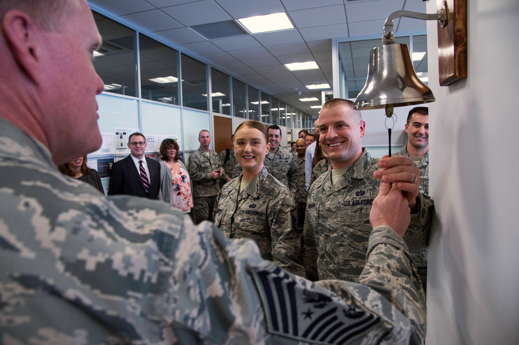 Chief Master Sgt. of the Air Force James Cody rings the victory bell with Air Force Legal Operations Agency Airmen during his visit at Joint Base Andrews, Md., March 23, 2015. The bell is rang when there is a legal victory in the office. (U.S. Air Force photo/Airman 1st Class Philip Bryant)