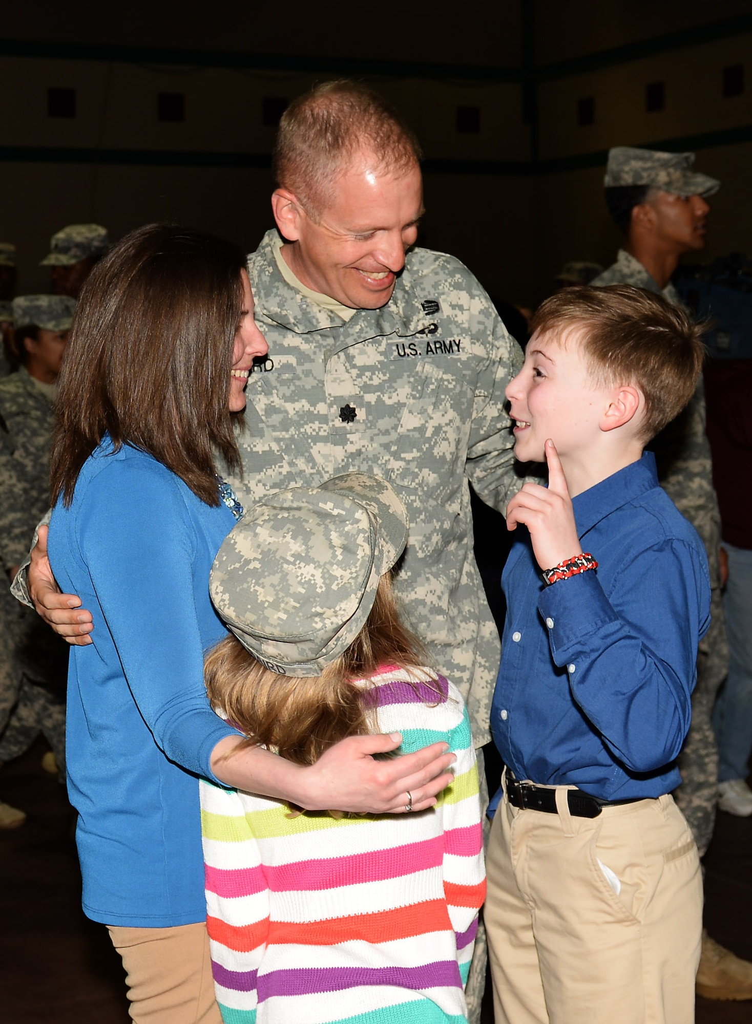 U.S. Army Lt. Col. Kevin Baird, 53rd Transportation Battalion (Movement Control), Headquarters and Headquarters Detachment, 7th Transportation Brigade (Expeditionary) commander, greets his wife, Elizabeth, and their children Matthew and Kristen, during a redeployment ceremony at Fort Eustis, Va., March 23, 2015. The detachment deployed to West Africa in support of the Department of Defense's response to the U.S. Agency for International Development's efforts to counter the Ebola outbreak. (U.S. Air Force photo by Staff Sgt. Teresa J. Cleveland/Released)