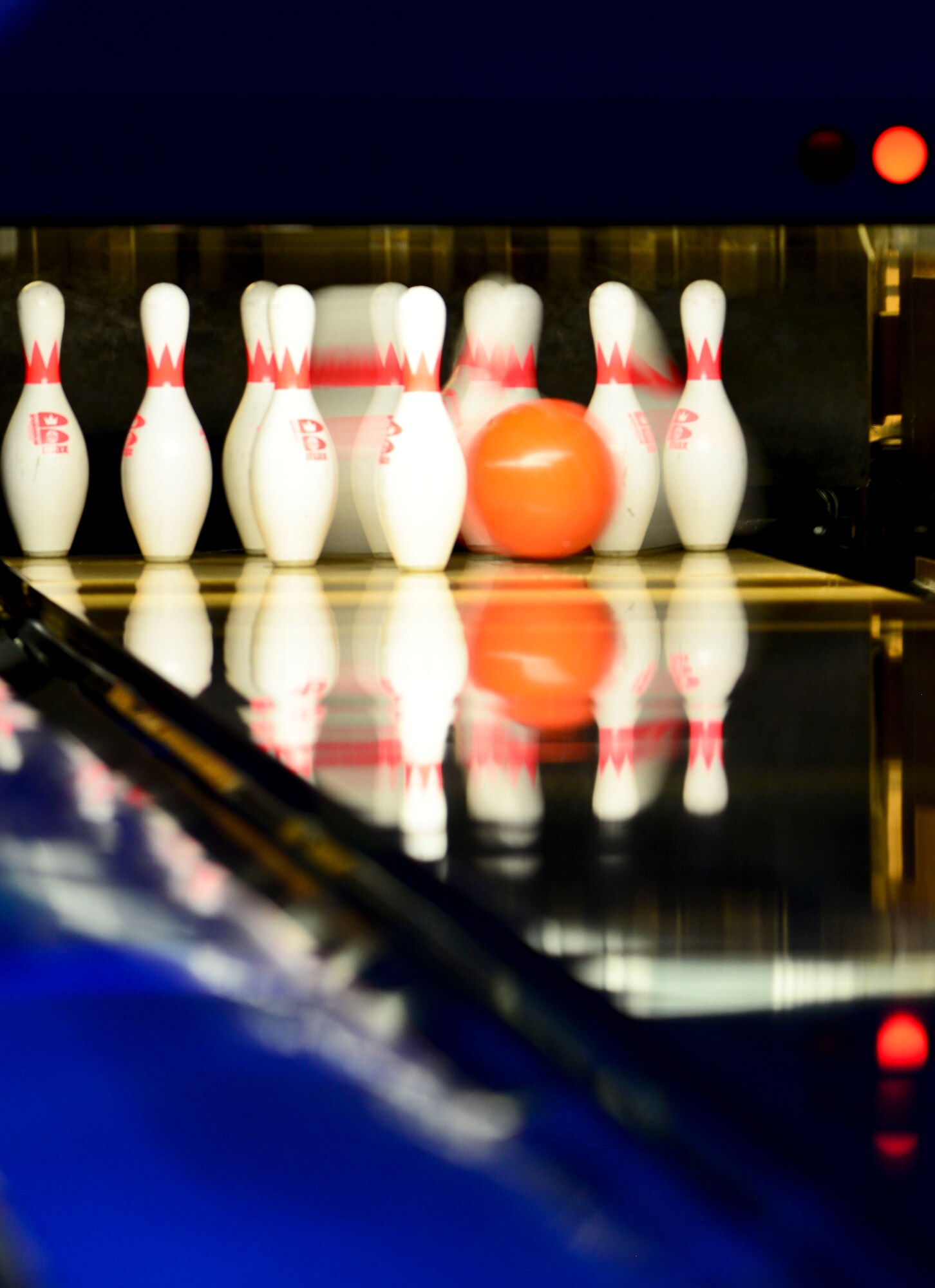 A bowling ball strikes pins during the Langley First Sergeants Council annual bowling event at Langley Air Force Base, Va., March 20, 2015. At the conclusion of the tournament, three prizes were awarded for placing teams. (U.S. Air Force photo by Senior Airman Kimberly Nagle/Released)