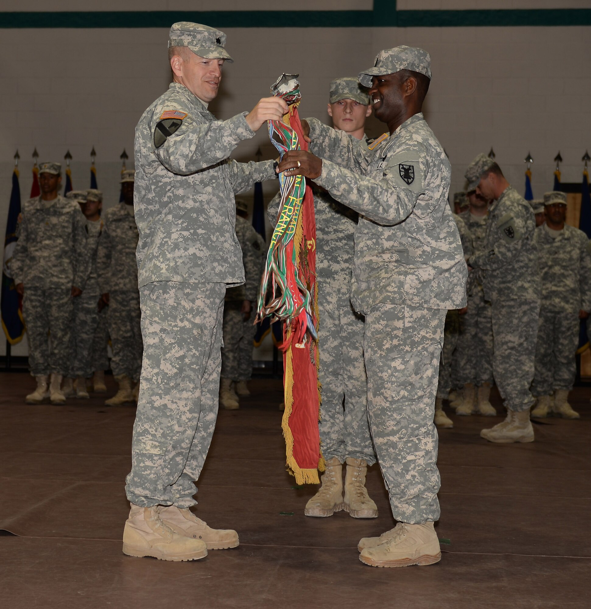 U.S. Army Lt. Col. Kevin Baird, 53rd Transportation Battalion (Movement Control), Headquarters and Headquarters Detachment, 7th Transportation Brigade (Expeditionary) commander, and 1st Sgt. Calvin Liggons, 53rd Trans. Btn. command sergeant major, uncase the detachment’s guidon during a redeployment ceremony at Fort Eustis, Va., March 23, 2015. The battalion deployed to West Africa in support of Operation United Assistance. (U.S. Air Force photo by Staff Sgt. Teresa J. Cleveland/Released)