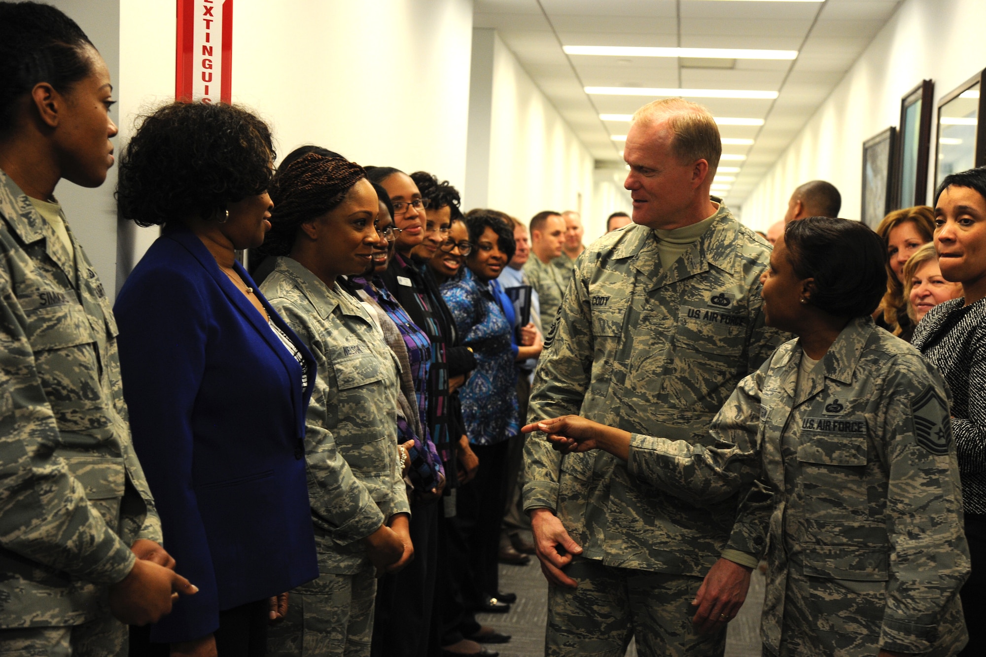Senior Master Sgt. Marjon Robertson introduces Chief Master Sgt. of the Air Force James Cody to Airmen assigned to the Air Force District of Washington Manpower, Personnel, and Services directorate during his visit at Joint Base Andrews, Md., March 23, 2015. Robertson is the Manpower, Personnel, and Services superintendent. (U.S. Air Force photo/Master Sgt. Tammie Moore)