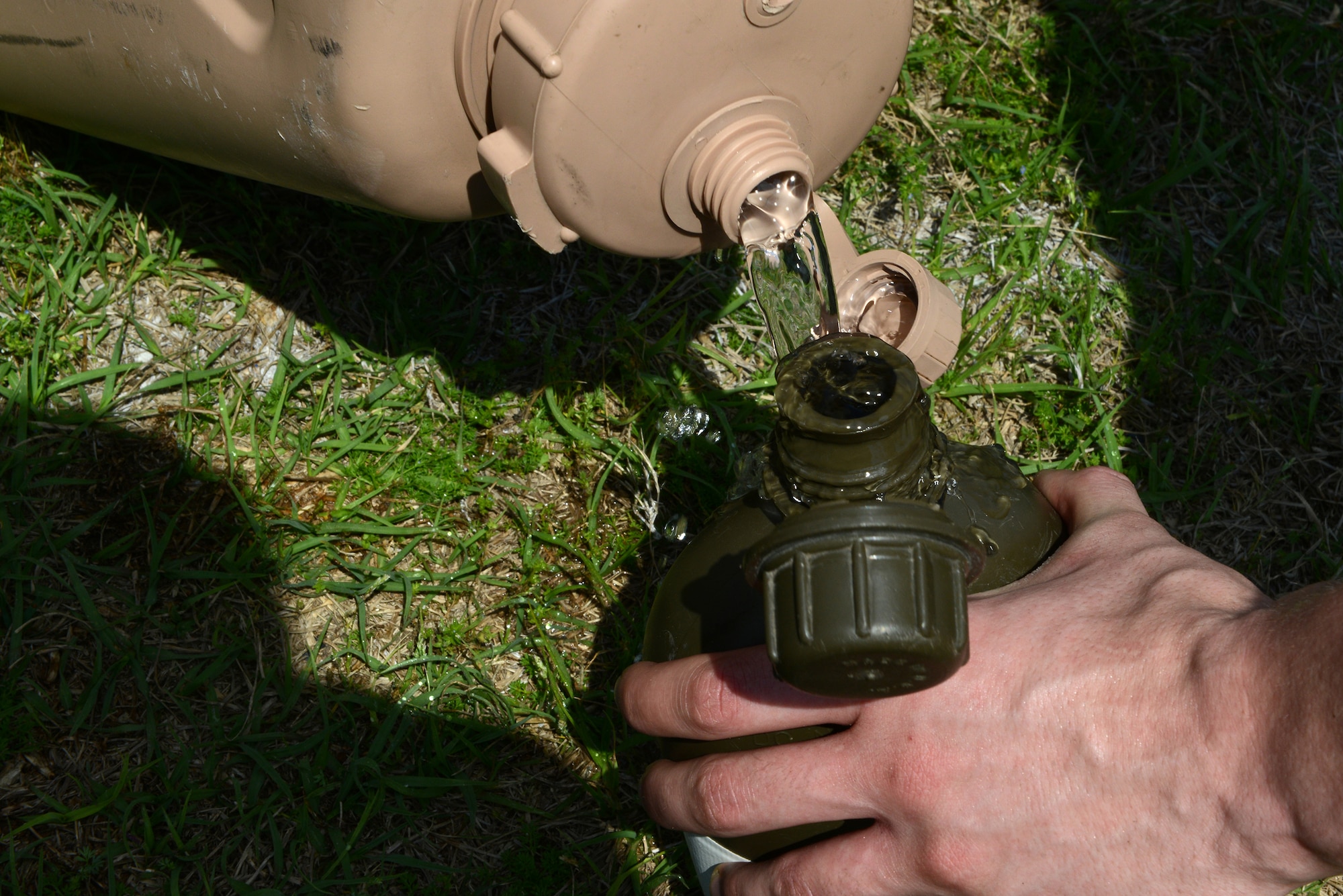 A tactical air control party candidate refills his canteen during the physical ability stamina test March 20, 2015, at Moody Air Force Base, Ga. The candidates were required to complete the PAST in order to continue the Air Liaison Officer Aptitude Assessment. (U.S. Air Force photo by Airman 1st Class Kathleen D. Bryant/Released)