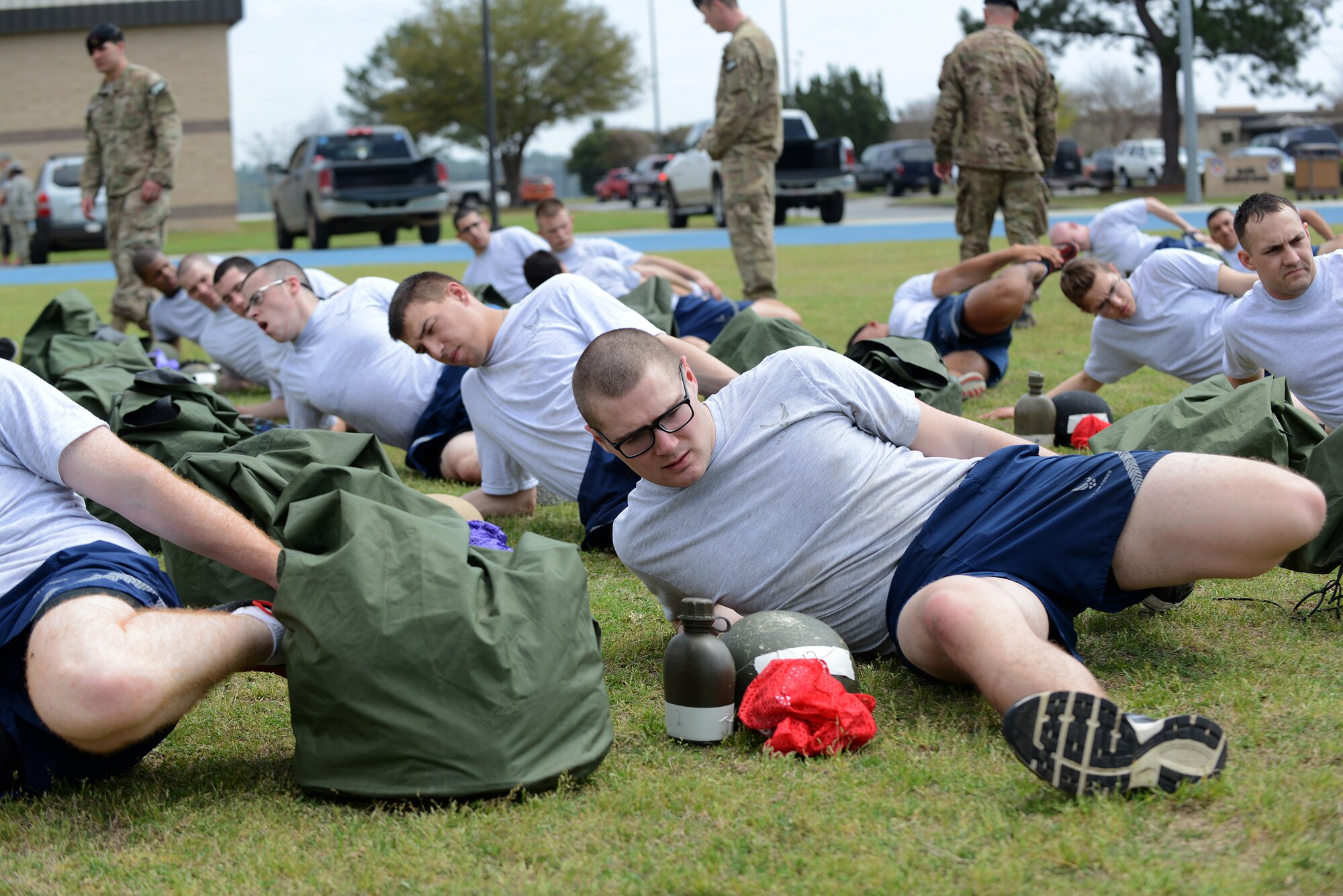 Tactical air control party candidates stretch before performing a 1.5-mile run for the physical ability and stamina test March 20, 2015, at Moody Air Force Base, Ga. The PAST, the first part of the Air Liaison Officer Aptitude Assessment, consisted of a 1.5-mile run and timed portion of sit-ups, pushups and pull-ups to initially qualify. (U.S. Air Force photo by Airman 1st Class Kathleen D. Bryant/Released)