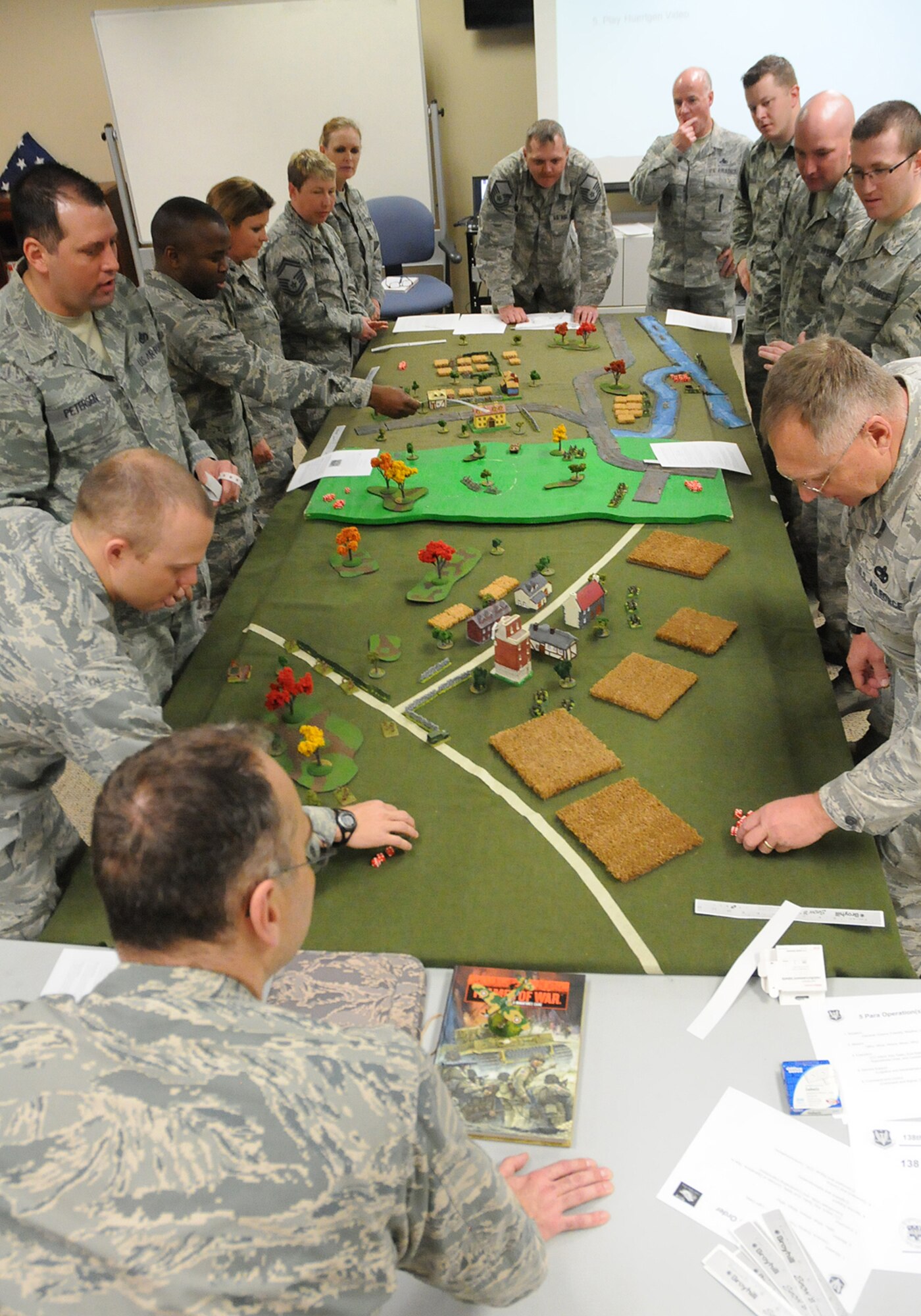 Members of the 138th Fighter Wing discuss the concept of operations during a table top exercise at a leadership meeting held Mar. 18, 2015, at the Tulsa Air National Guard Base, Okla.   Since August 2014, every Wednesday following their monthly unit training assembly, leaders from around the 138th Fighter Wing have shared various leadership perspectives, and encouraged open and honest communication while learning from each other at wing leadership meetings .  (U.S. National Guard photo by Senior Master Sgt.  Preston L. Chasteen/Released)