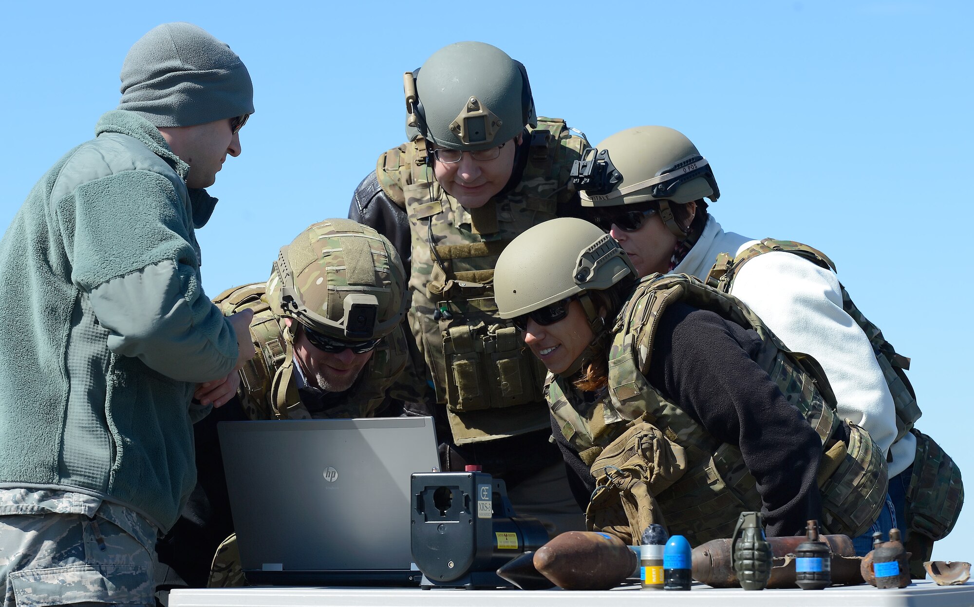 Senior Airman Andrew Vitale, 436th Mission Support Group Explosive Ordnance Disposal bomb technician, left, shows x-rays of a suspicious package being displayed on the laptop computer to a group of honorary commanders who lean in while examining the details March 18, 2015, on Dover Air Force Base, Del. The 2015 Dover Air Force Base, Del. Honorary Commanders took part in a tour of the 436th Mission Support Group to better understand the Group's mission and how the subordinate squadrons execute their missions. (U.S. Air Force photo/Greg L. Davis)