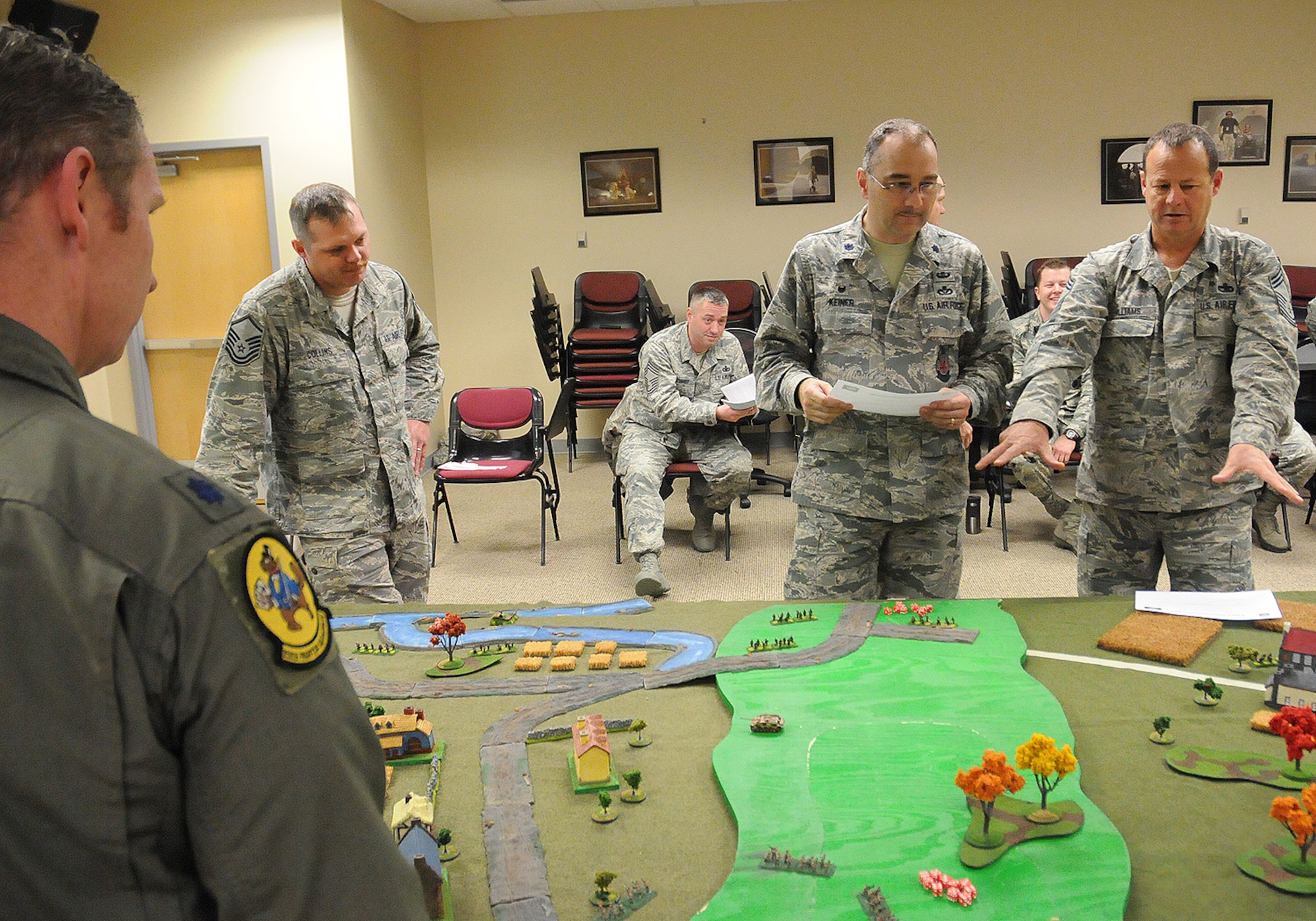 Chief Master Sgt. Brian Williams, 138th Maintenance Group discusses the concept of operations during a table top exercise with Lt. Col. Martin Keiner, 138th Base Civil Engineer, during a leadership meeting held Mar. 18, 2015, at the Tulsa Air National Guard Base, Okla.   Since August 2014, every Wednesday following their monthly unit training assembly, leaders from around the 138th Fighter Wing have shared various leadership perspectives, and encouraged open and honest communication while learning from each other at wing leadership meetings .  (U.S. National Guard photo by Senior Master Sgt.  Preston L. Chasteen/Released)