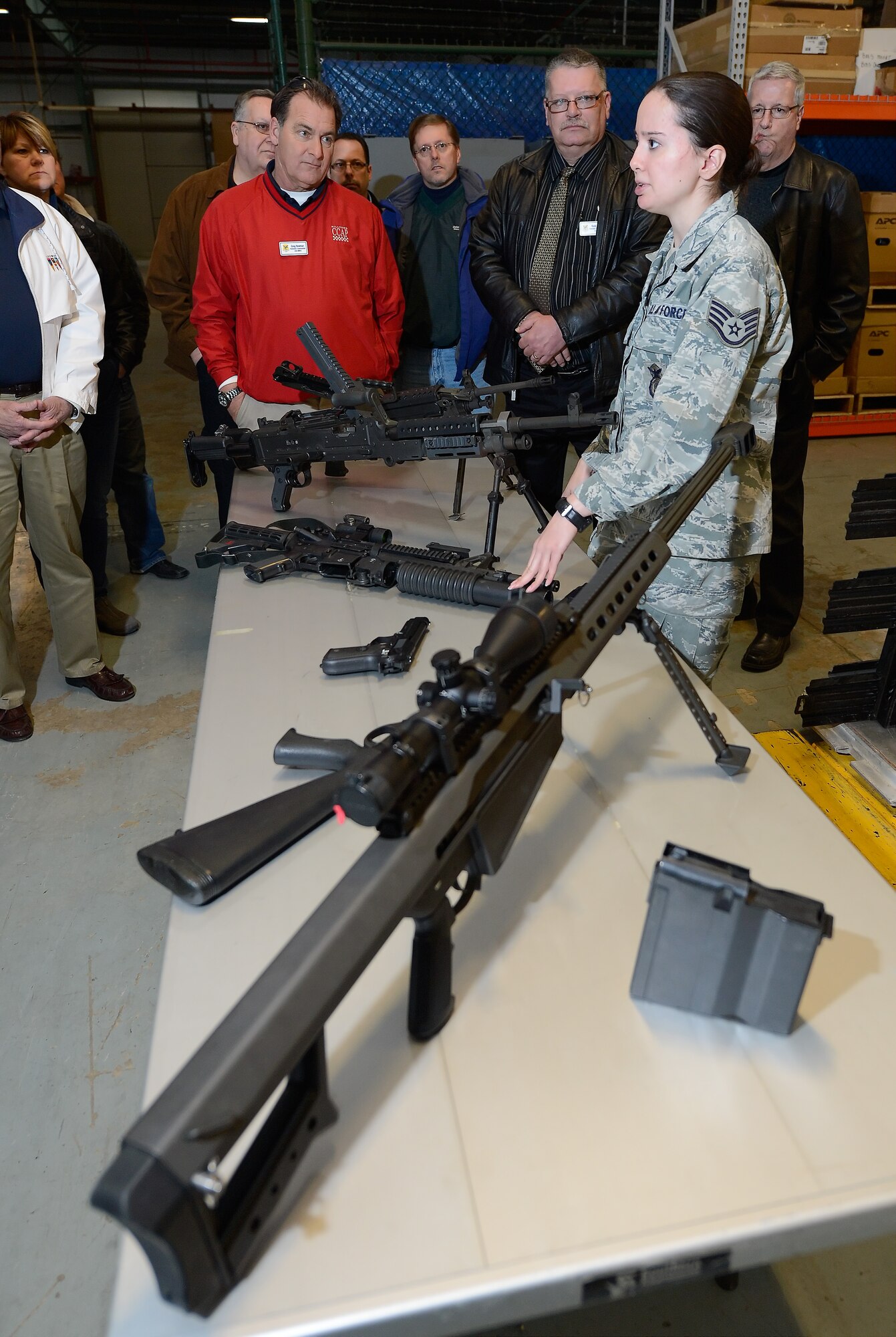 Staff Sgt. Misty Skiles, 436th Security Forces Squadron combat arms instructor, showcases a variety of weapons used within the 436th Mission Support Group during a tour given to the 2015 Dover Air Force Base Honorary Commanders March 18, 2015, on Dover Air Force Base, Del. Skiles explained the need, use and training regiment for security forces and explosive ordnance disposal personnel in her briefing. (U.S. Air Force photo/Greg L. Davis)