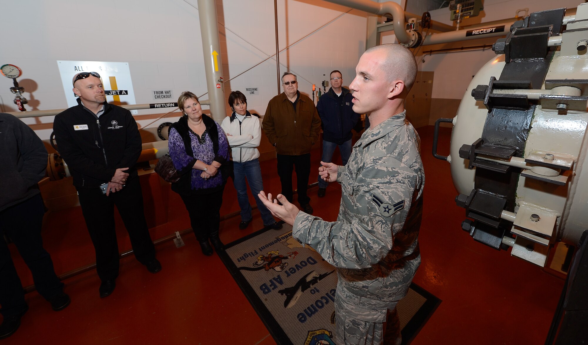 Airman 1st Class Chance Scharer, 436th Logistics Readiness Squadron, briefs a group of Honorary Commanders on the petroleum pump house during a tour of the 436th Mission Support Group March 18, 2015, on Dover Air Force Base, Del. The facility moves fuel from large storage tanks to underground delivery stations on the flight line at single-point refueling stations. (U.S. Air Force photo/Greg L. Davis)