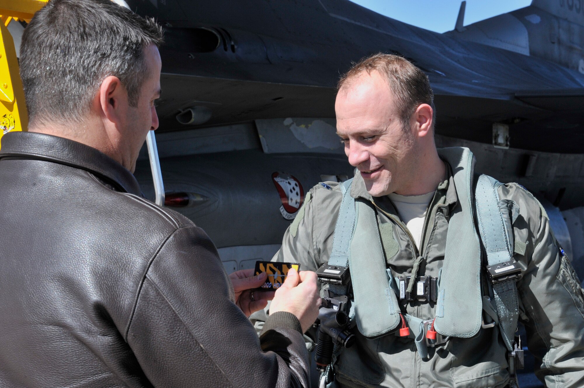 U.S. Air Force Lt. Col. Raymond Millero Jr., 79th Fighter Squadron commander, receives a 3,000 hour patch from Lt. Col. Andrew Caggiano, 79th FS director of operations, at Shaw Air Force Base, S.C., Feb. 19, 2015. Millero has been flying the F-16 Fighting Falcon for 18 years and has flown 1,832 missions in the aircraft. (U.S. Air Force photo by Airman 1st Class Jonathan Bass/Released)