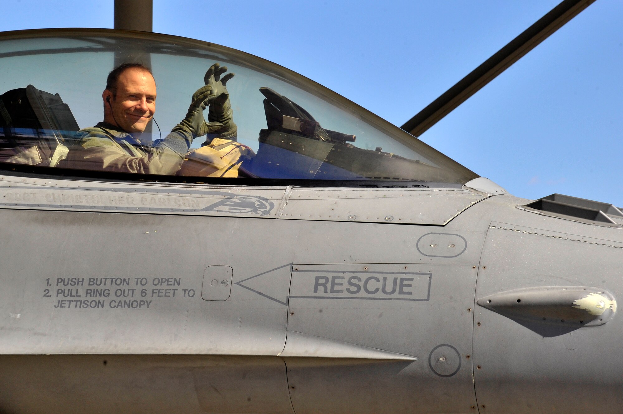 U.S. Air Force Lt. Col. Raymond Millero Jr., 79th Fighter Squadron commander, holds up the 79th FS’s hand sign after landing from his 3,000th hour of flight time in the F-16 Fighting Falcon at Shaw Air Force Base, S.C., Feb. 19, 2015. Millero is one of 260 pilots in the world to have achieved that many hours in the F-16. (U.S. Air Force photo by Airman 1st Class Jonathan Bass/Released)