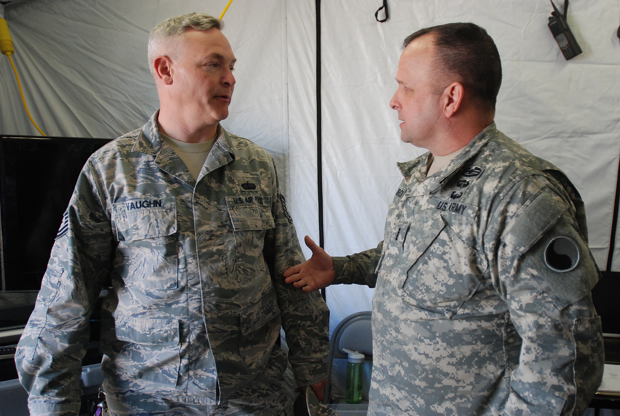 Tech Sgt. Kevin Vaughn (left), an interoperability coordinator with the South Carolina Air National Guard’s 169th Communications Flight and Chief Warrant Officer 4 Ed Marquis (right), a tactical communications officer with the Virginia Army National Guard’s 29th Infantry Division, discuss interagency communication at a Vigilant Guard exercise March 8, 2015 in Georgetown, S.C. Vigilant Guard is a series of federally funded disaster-response drills conducted by National Guard units working with federal, state and local emergency management agencies and first responders. (U.S. Army National Guard photo by Master Sgt. A.J. Coyne/Released)