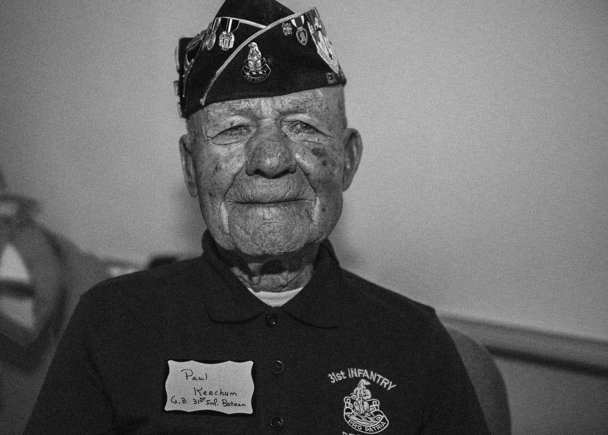 Paul Kerchum, a Bataan Death March survivor, poses for a photo after telling spectators about his involvement in the BDM at the Post Theater, White Sands Missile Range, N.M. March 21, 2015. On April 9, 1942, after Gen. Edward King surrendered the 75,000 American and Filipino troops at the Bataan Peninsula in the Philippines, the troops were forced on what was later named the Bataan Death March. During the 65-mile march, prisoners of war were beaten, starved, and thousands died or were killed. Many of those captured were from New Mexico’s National Guard. For that reason, every March at WSMR, thousands of participants march either 14.2, or 26.2 miles in honor of those who made the march, or made the ultimate sacrifice. (U.S. Air Force photo by Airman 1st Class Emily A. Kenney/Released)   