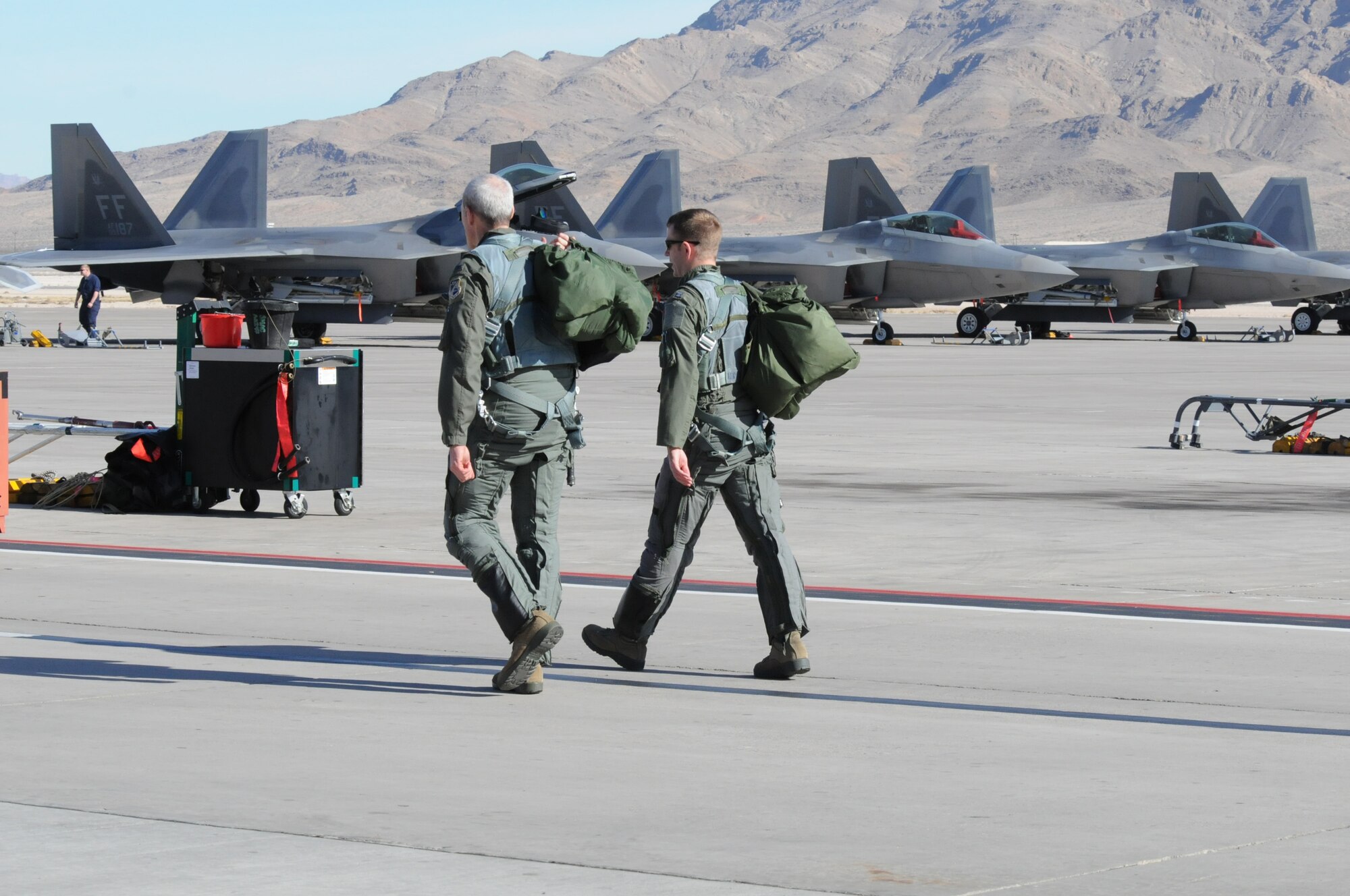 Colonel Robert Grey (left), 192nd Fighter Wing Commander and a 1st Fighter Wing pilot, both from Joint Base Langley-Eustis, Va., step to their jets during the 40th anniversary of the Red Flag combat training exercise, Red Flag 15-1 at Nellis Air Force Base, Nev., Feb. 3, 2015.  Red Flag is a realistic combat training exercise involving the air, space and cyber forces of the U.S. and its allies. It is conducted on the bombing and gunnery ranges on the Nevada Test and Training Range. (U.S. Air National Guard photo by Master Sgt. Carlos J. Claudio/Released)
