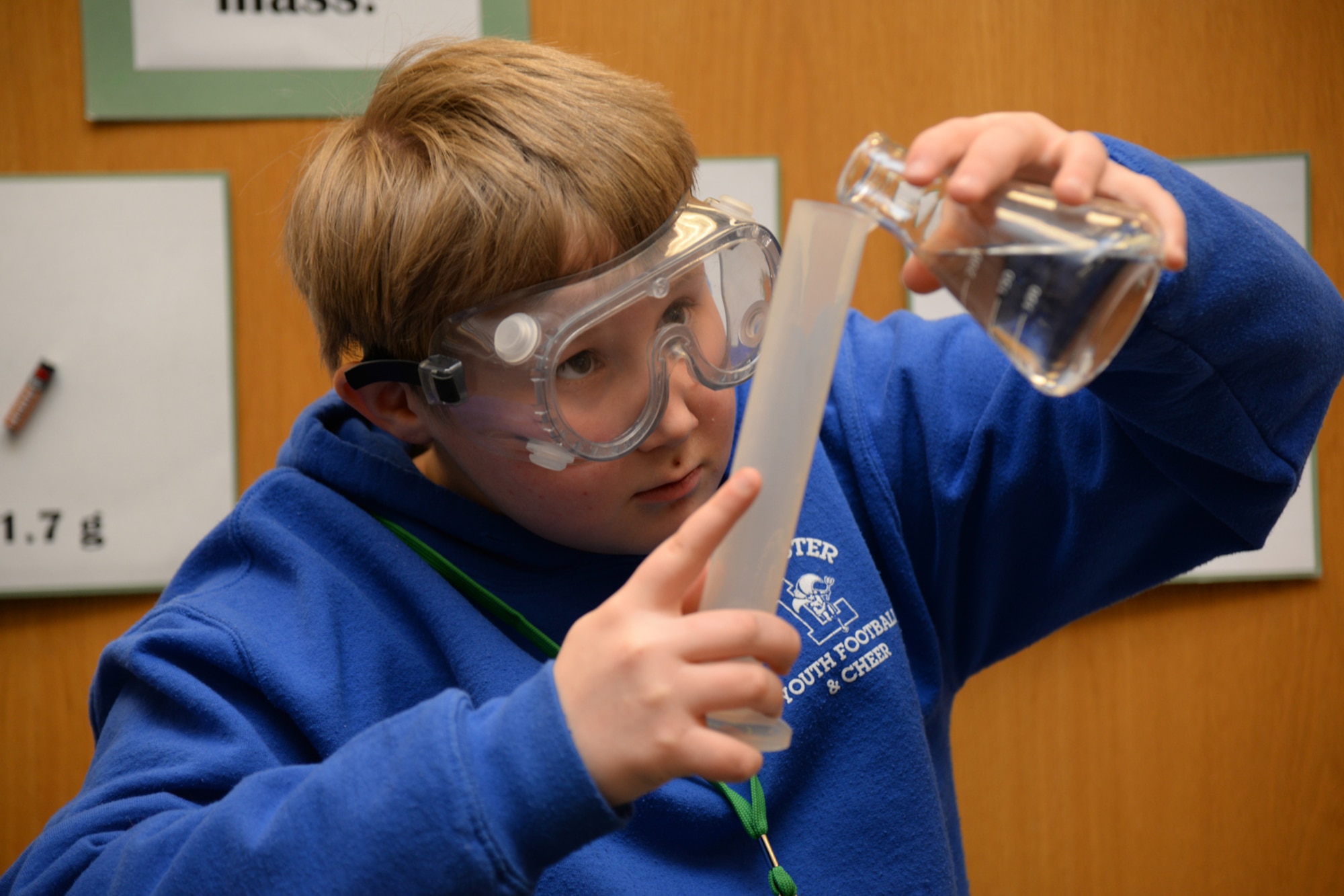 Caleb Roberts, age 10, a fifth grader from Leominster, Mass., carefully measures fluid for a rocket experiment at Hanscom's STARBASE center, March 20. Roberts was among a small group of students who visited STARBASE to learn about STEM. A CBS news crew was also on hand to interview Roberts and others as part in a larger "Eye on Education" series focusing on state-wide education initiatives. (U.S. Air Force photo by Linda LaBonte-Britt)