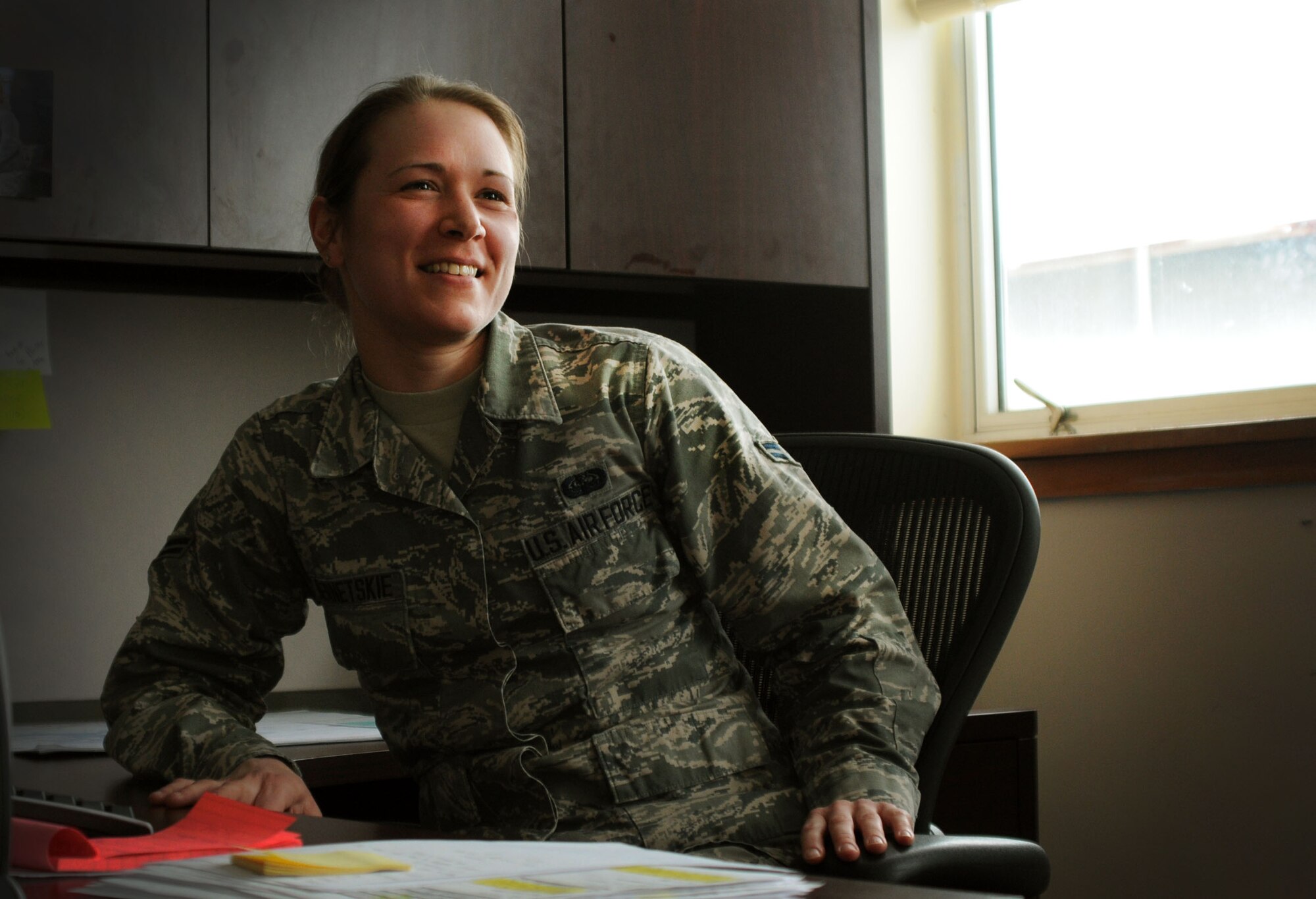 Senior Airman Stacey Bernetskie, 111th Communications Flight client systems technician, smiles while talking with co-workers during the unit training assembly on March 8, 2015, Horsham Air Guard Station, Pennsylvania. Bernetskie is working toward her childhood dream of becoming an Air Force pilot. (U.S. Air National Guard photo by Tech. Sgt. Andria Allmond/Released)