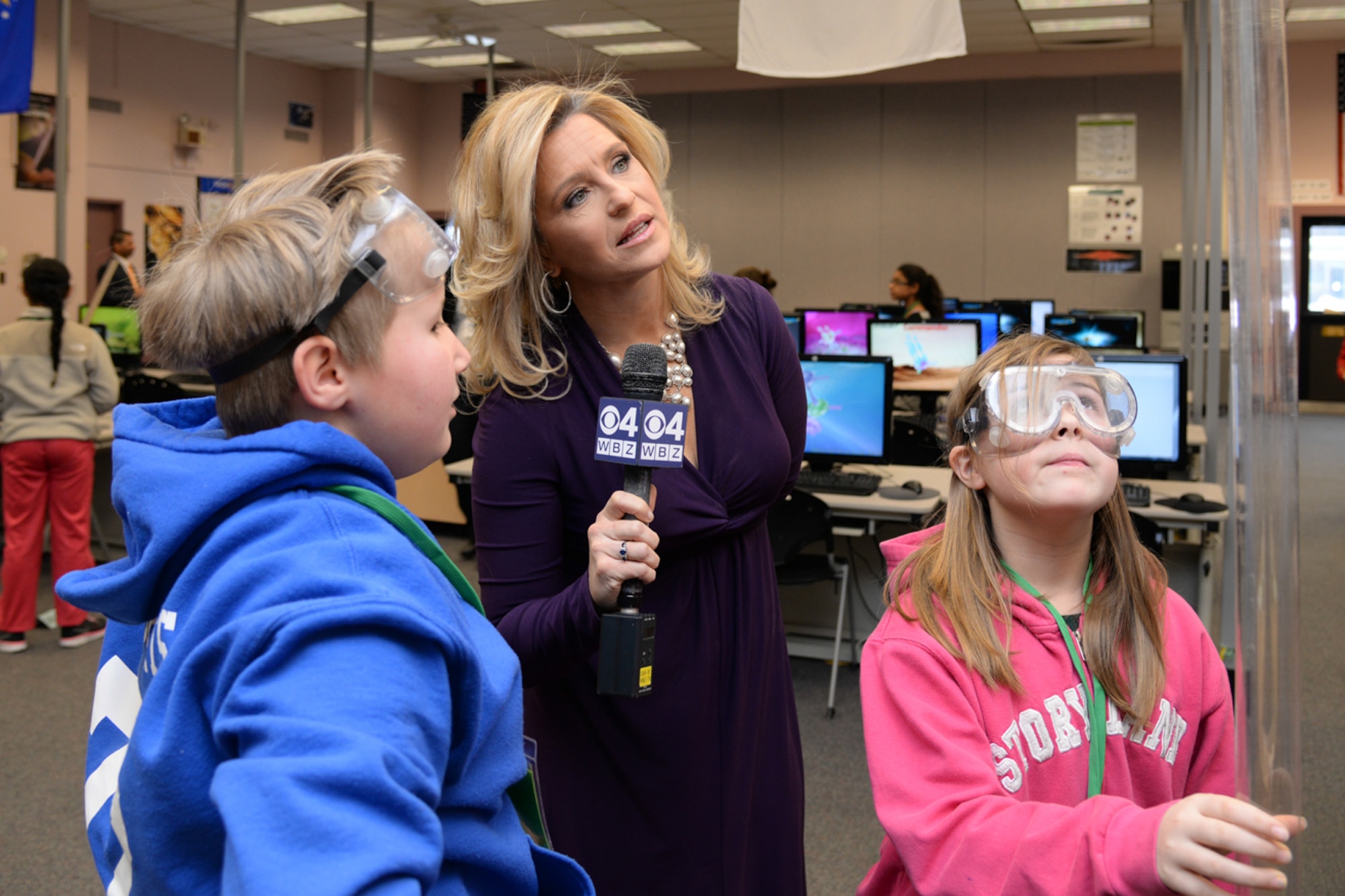 Reporter Paula Ebben, news anchor for Boston's WBZ-TV, speaks to Caleb Roberts, 10, and Lauri Young, 11, about a rocket experiment at Hanscom Air Force Base's STARBASE Academy, March 20. Both Young and Roberts are fifth grade students from Leominster, Mass., who are learning about science technology, engineering and mathematics areas at STARBASE.