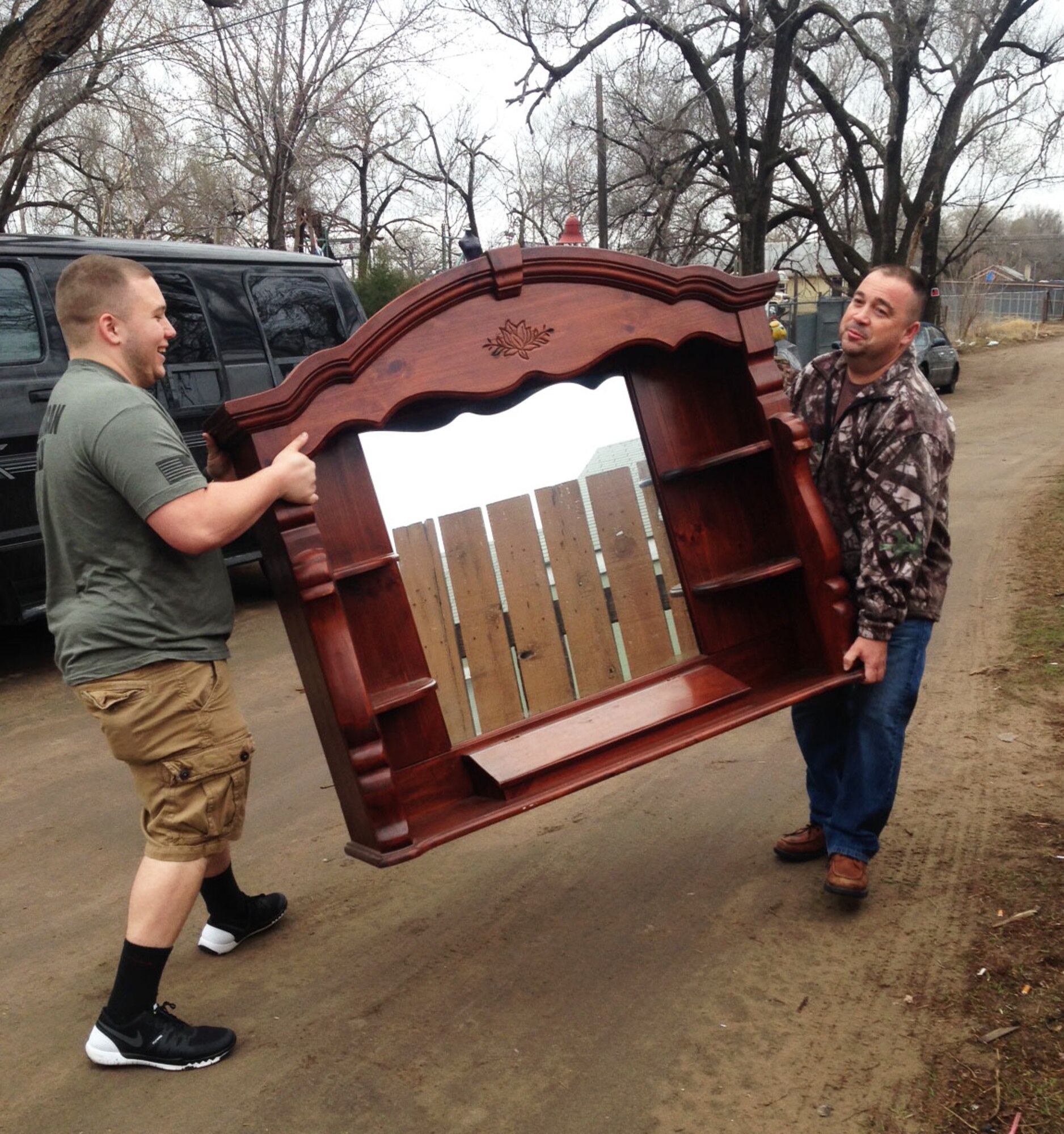 (Left to right) Christian Peel and his father, Senior Master Sgt. Eric Peel, 931st Aircraft Maintenance Squadron production superintendent, carry part of a bedframe for a veteran moving into new housing in Wichita, Kan., March 19, 2015. McConnell Airmen, the Robert J. Dole Veterans Administration Medical Center and His Helping Hands, a local non-profit, are all working together to end veteran homelessness. (U.S. Air Force photo by Tech. Sgt. Abigail Klein)
