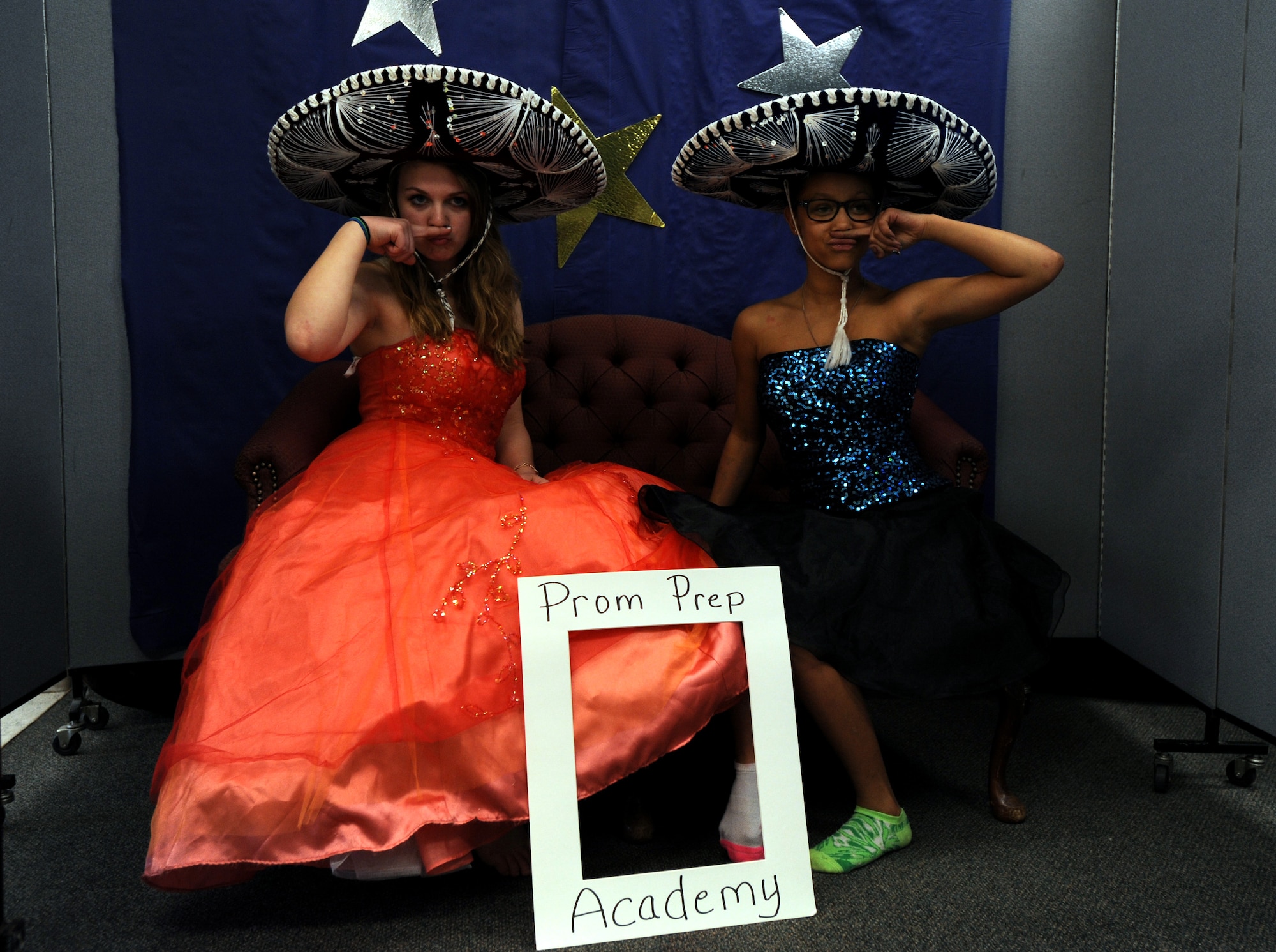 Peyton Stanich, 14, and Haleigh Rosencrans, 13, pose in the photo booth March 21, 2015, at the Prom Prep Academy event at the Grand Forks Air Force Base Youth Center here. Prom Prep Academy was designed to give youth age 12 and up the opportunity to be taught about how to style their hair, nails and makeup. Teens were also afforded the opportunity to choose from a variety of prom outfits donated for the event. (U.S. Air Force photo/Staff Sgt. Susan L. Davis)