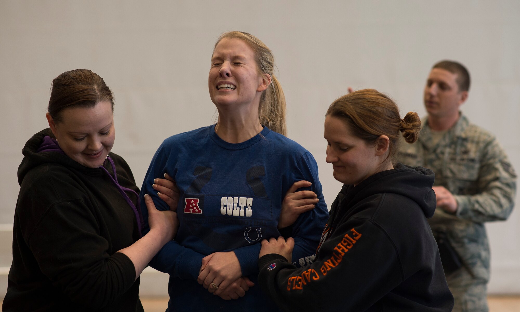 Senior Airman Jessica Hennessee, 86th Communications Squadron theater secure voice systems technician, is shocked by a Taser during a self-defense seminar at Ramstein Air Force Base, Germany, March 20, 2015. Attendees of the seminar had the option to experience firsthand the effects of being immobilized by a stun gun. (U.S. Air Force photo/Senior Airman Damon Kasberg)