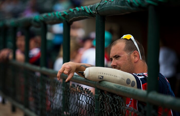 Leonard Anderson, Wounded Warrior Amputee Softball Team member, watches his teammates play during the “Battle of Charleston Harbor” softball tournament March 21, 2015, at Joe Riley Stadium in Charleston, S.C. The mission of the WWAST is to raise awareness, through exhibition and celebrity softball games, of the sacrifices and resilience of our military and highlight their ability to rise above any challenge. Their goal is to show other amputees and the general public, that these athletes, through extensive rehabilitation and training, are able to express their desires and perform the sport they love. (U.S. Air Force photo/Airman 1st Class Clayton Cupit)