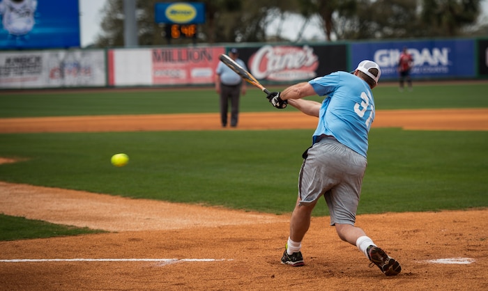 Scott Elvington, Citadel Alumni, hits a groundball during the “Battle of Charleston Harbor” softball tournament March 21, 2015, at Joe Riley Stadium in Charleston, S.C. The “Battle of Charleston Harbor” was a softball game between the Wounded Warrior Amputee Softball Team and the Citadel 1990 College World Series baseball team. (U.S. Air Force photo/Airman 1st Class Clayton Cupit)