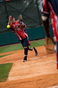 Mike Dreyer, Wounded Warrior Amputee Softball Team member, pitches a softball during the “Battle of Charleston Harbor” softball tournament March 21, 2015, at Joe Riley Stadium in Charleston, S.C. The WWAST is comprised of young, competitive, athletic veterans and active duty soldiers who have lost limbs post-9/11, while serving their country in the military. Some are still in the service, others are attending college thanks to the Post-9/11 GI Bill, while others have moved on to new careers. (U.S. Air Force photo/Airman 1st Class Clayton Cupit)