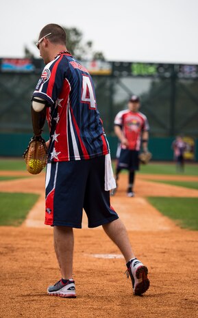 Leonard Anderson, Wounded Warrior Amputee Softball Team member, catches a softball during the “Battle of Charleston Harbor” softball tournament March 21, 2015, at Joe Riley Stadium in Charleston, S.C. The mission of the WWAST is to raise awareness, through exhibition and celebrity softball games, of the sacrifices and resilience of our military and highlight their ability to rise above any challenge. Their goal is to show other amputees and the general public, that these athletes, through extensive rehabilitation and training, are able to express their desires and perform the sport they love. (U.S. Air Force photo/Airman 1st Class Clayton Cupit)