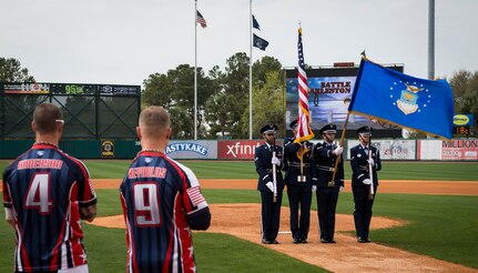 Joint Base Charleston Honor Guardsmen present the colors while the National Anthem is performed March 21, 2015, at Joe Riley Stadium in Charleston, S.C. The “Battle of Charleston Harbor” was a softball game between the Wounded Warrior Amputee Softball Team and the Citadel 1990 College World Series baseball team. (U.S. Air Force photo/Airman 1st Class Clayton Cupit)