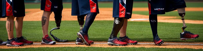 Members of the Wounded Warrior Amputee Softball Team line up on the field  for the playing of the National Anthem March 21, 2015, at Joe Riley Stadium in Charleston, S.C. The WWAST is a charitable organization whose mission is to raise awareness, educate and inspire the public about the strength and resiliency of the wounded warriors.  The WWAST accomplish their mission by showing how a positive attitude, commitment, dedication and perseverance enable them to overcome any obstacle. (U.S. Air Force photo/Airman 1st Class Clayton Cupit)