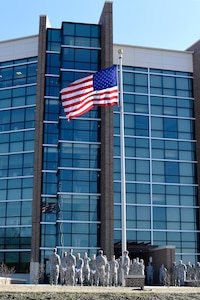 Team Andrews members prepare to retire one of the installation flags located in front of the Jones Building on Joint Base Andrews, Md., March 23, 2015. According to the U.S. Flag code, “the flag, when it is in such condition that it is no longer a fitting emblem for display, should be destroyed in a dignified way, preferably by burning.” (U.S. Air Force photo/Airman 1st Class Ryan J. Sonnier)