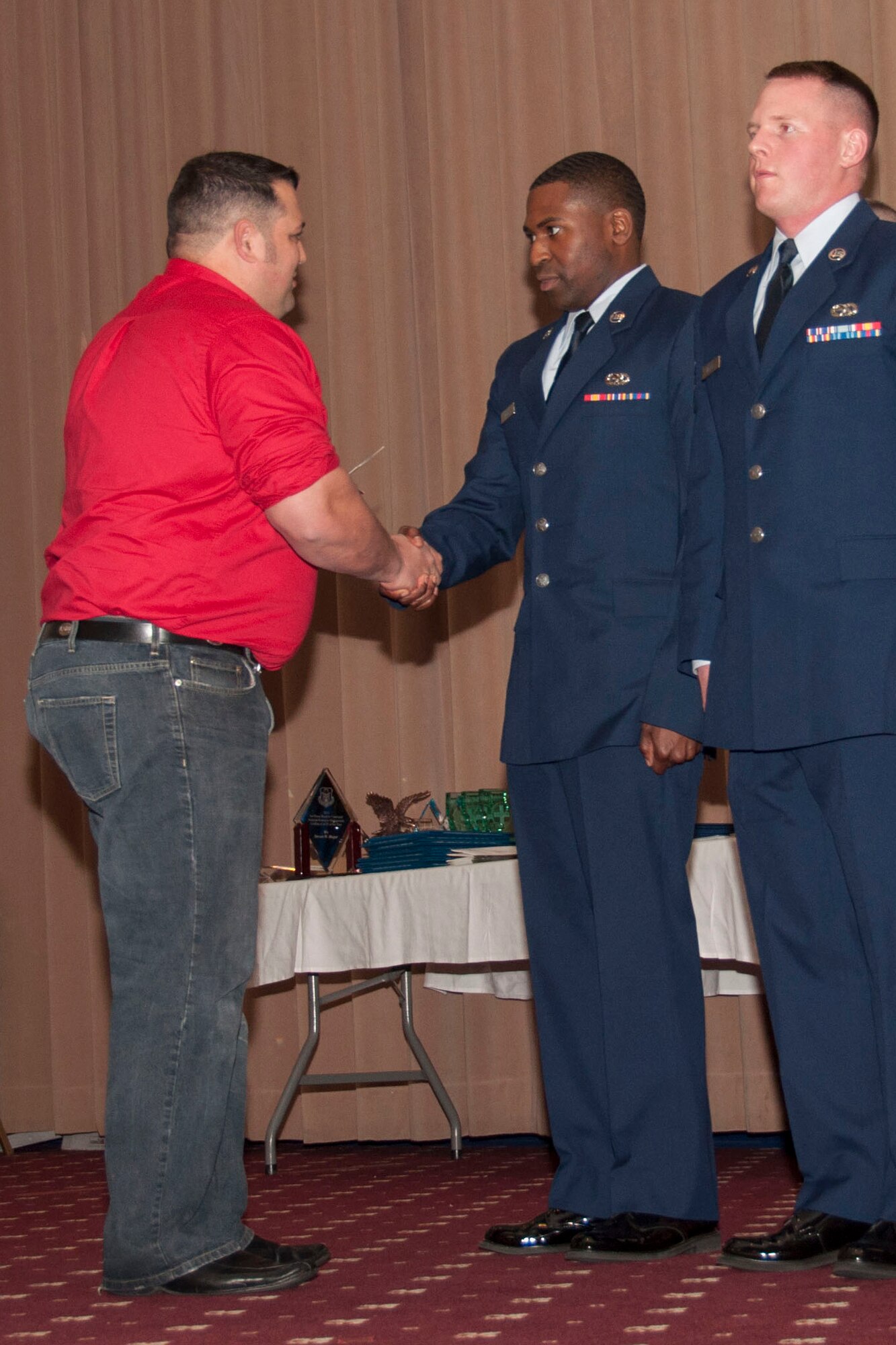 Jack “Bump” Skaggs, the Owner/Operator of Smashburger in Shreveport and Bossier City, congratulates U.S. Air Force Airman 1st Class Joseph Moore with a gift for being selected as the Airmen of the Quarter for the third quarter of 2014 and Airman of the Year for 2014, March 8, 2015, Barksdale Air Force Base, La. Moore is assigned to the 307th Maintenance Squadron. (U.S. Air Force photo by Tech. Sgt. Theodore Daigle/Released)