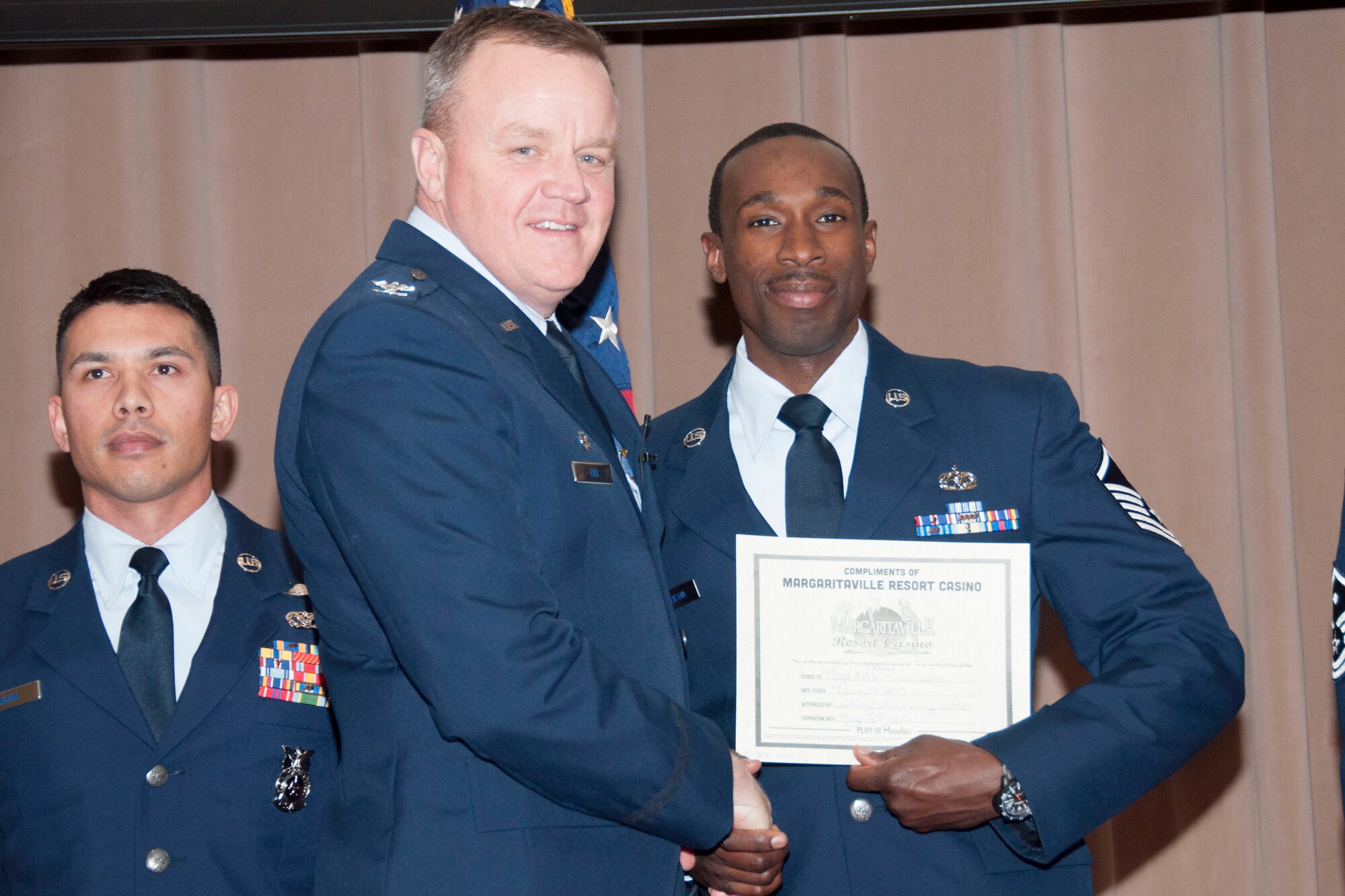U.S. Air Force Col. Bruce Cox, 307th Bomb Wing commander, congratulates Master Sgt. Kelvin Harrison for being selected as the Senior Noncommissioned Officer of the Quarter for the fourth quarter of 2014, March 8, 2015, Barksdale Air Force Base, La. Harrison is assigned to the 307th Maintenance Squadron. (U.S. Air Force photo by Tech. Sgt. Theodore Daigle/Released)