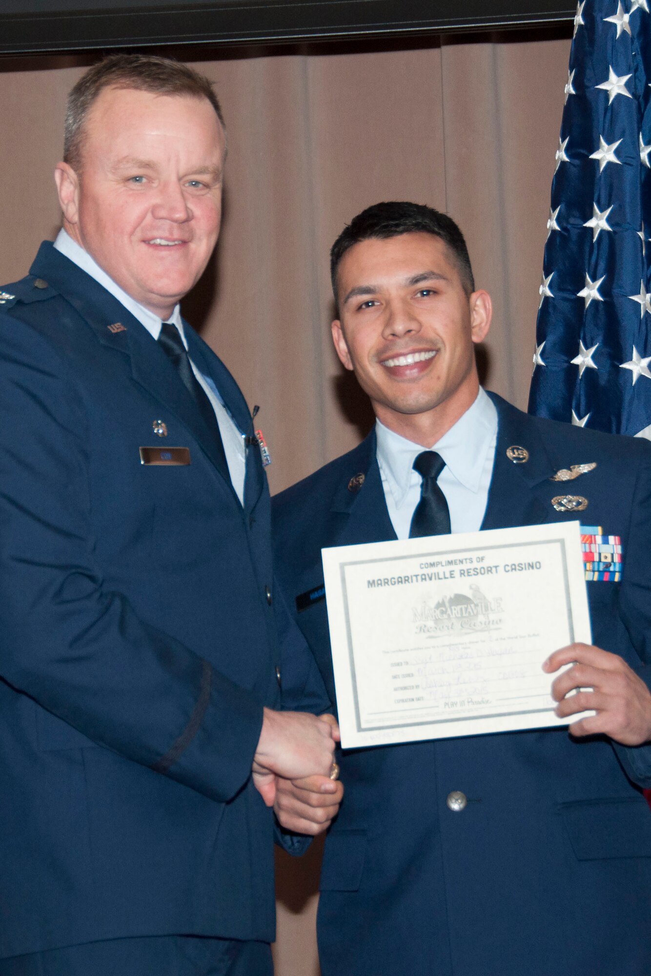 U.S. Air Force Col. Bruce Cox, 307th Bomb Wing commander, poses with Staff Sgt. Nicholas Hagan, the Noncommissioned Officer of the Quarter for the fourth quarter of 2014, March 8, 2015, Barksdale Air Force Base, La. Hagan is assigned to the 307th Civil Engineer Squadron was presented with a certificate from Margaritaville Resort Casino for his accomplishment. (U.S. Air Force photo by Tech. Sgt. Theodore Daigle/Released)
