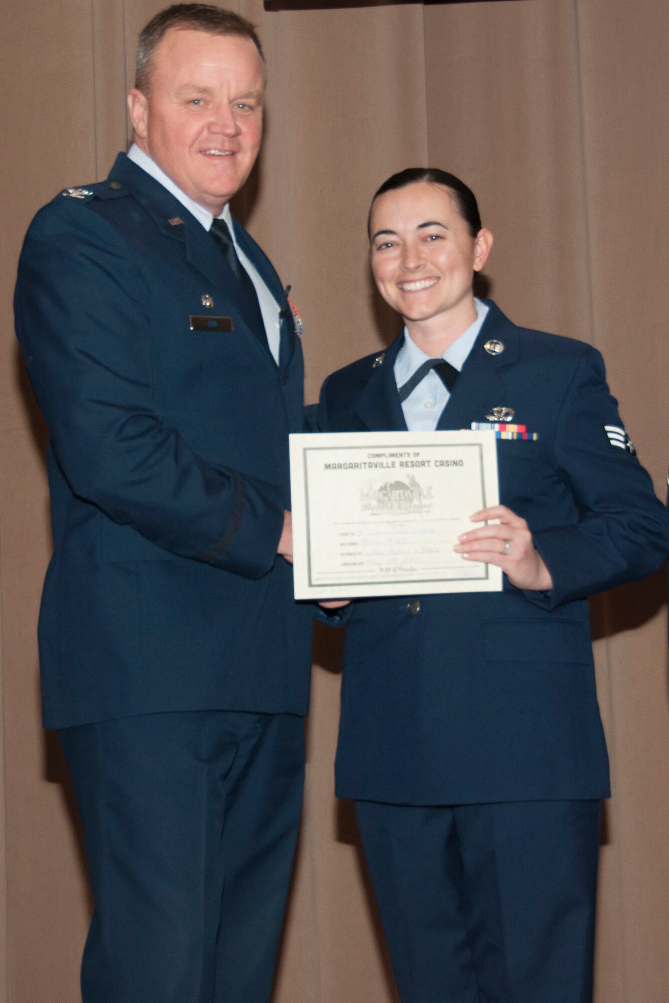 U.S. Air Force Col. Bruce Cox, 307th Bomb Wing commander, congratulates Senior Airman Callie Ware for being selected as the Airmen of the Quarter for the fourth quarter of 2014, March 8, 2015, Barksdale Air Force Base, La. Ware is assigned to the 307th RED HORSE Squadron. (U.S. Air Force photo by Tech. Sgt. Theodore Daigle/Released)