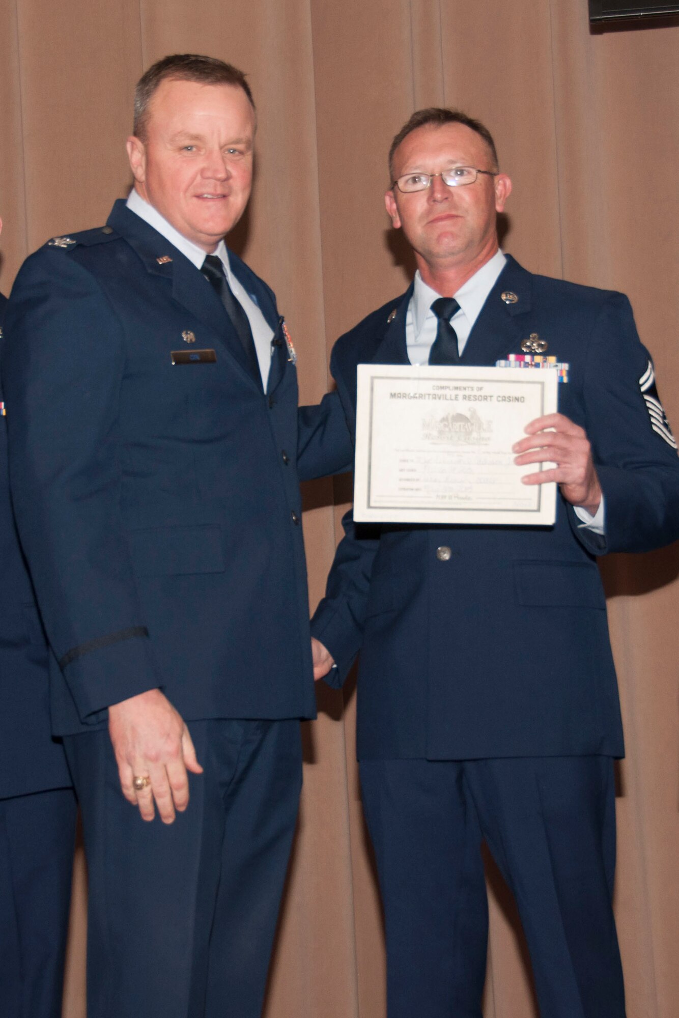 U.S. Air Force Col. Bruce Cox, 307th Bomb Wing commander, congratulates Senior Master Sgt. Kenneth Atchison Jr. for being selected as the Senior Noncommissioned Officer of the Quarter for the third quarter of 2014 and the Senior Noncommissioned Officer of the year for 2014, March 8, 2015, Barksdale Air Force Base, La. Atchison is assigned to the 307th Maintenance Squadron. (U.S. Air Force photo by Tech. Sgt. Theodore Daigle/Released)