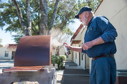 Victor Douglas, 802nd Force Support Squadron maintenance technician, spray paints a waste receptacle lid March 6 at the Joint Base San Antonio-Randolph Lodging Office. Douglas has worked for the JBSA-Randolph Lodging Office for 41 years. (U.S. Air Force photo by Airman 1st Class Stormy Archer)

