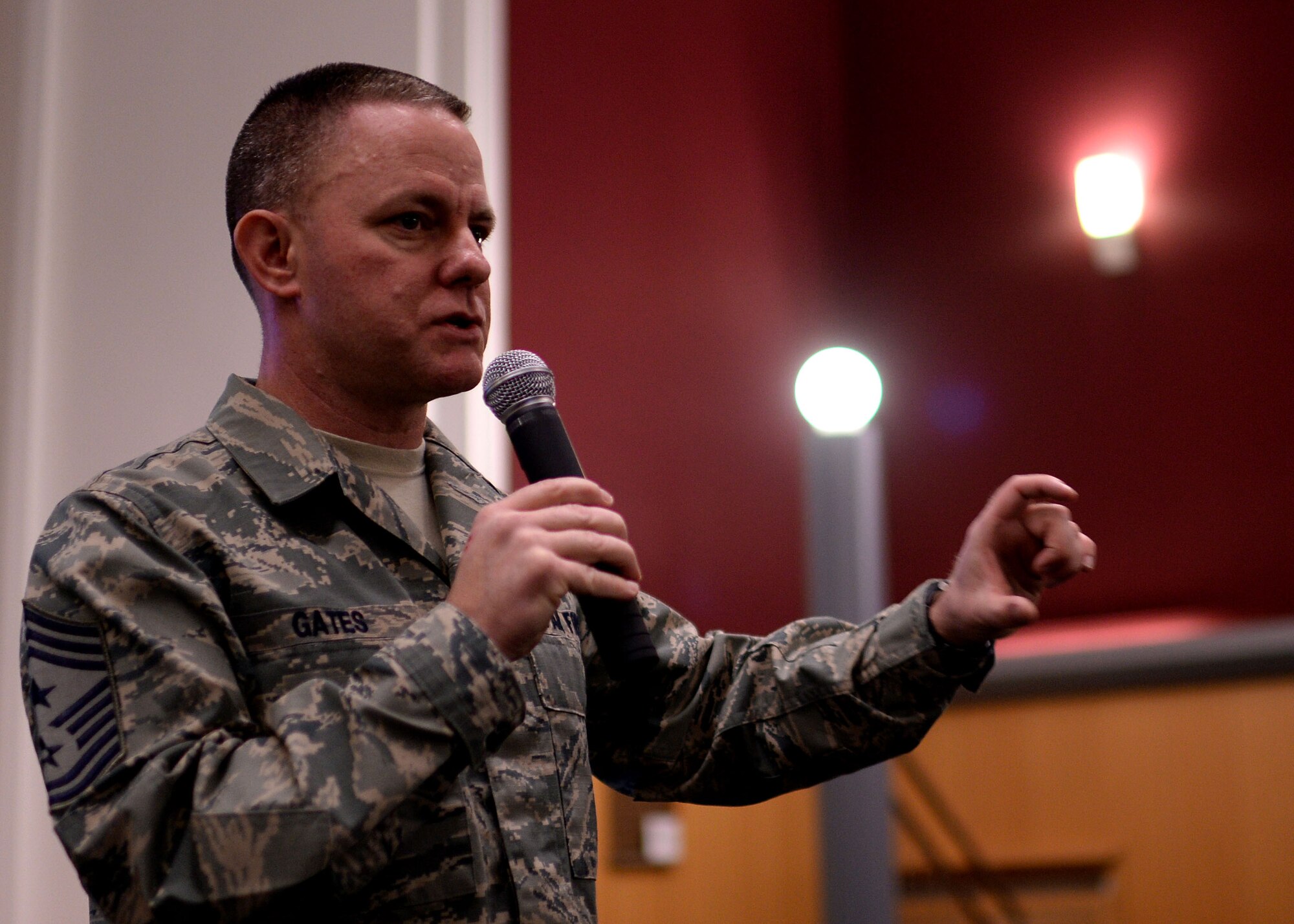 U.S. Air Force Chief Master Sgt. Brian Gates, 52nd Fighter Wing command chief, discusses enlisted issues during a mass briefing March 24, 2015, in the theater at Spangdahlem Air Base, Germany. After each topic, Gates asked for questions and feedback from the nearly 200 Airmen audience. (U.S. Air Force photo by Staff Sgt. Daryl Knee/Released)
