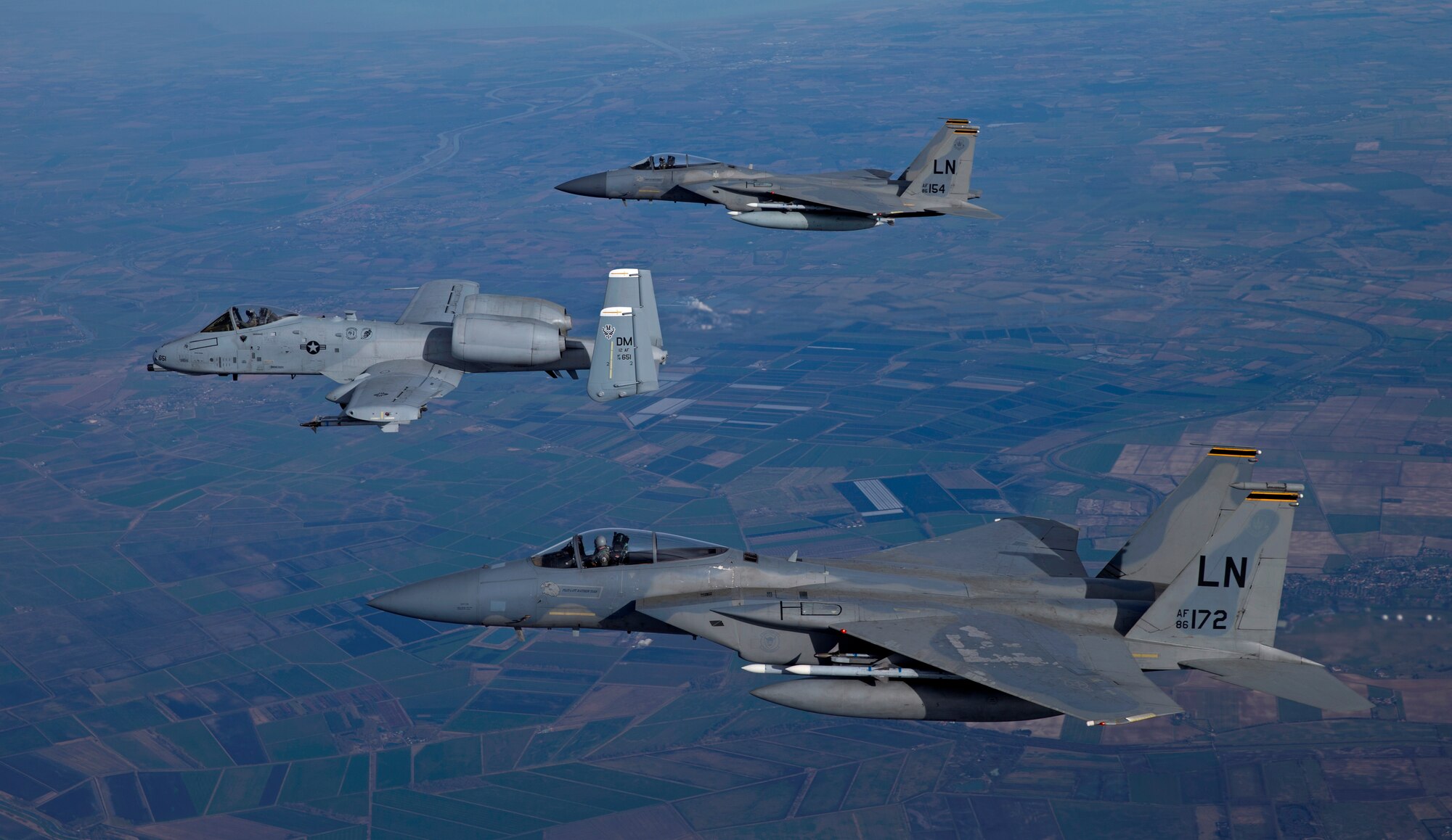 An A-10C Thunderbolt II from the 355th Fighter Wing flies with two F-15C Eagles from the 493rd Fighter Squadron, March 13, 2015. The A-10s were deployed out of Davis-Monthan Air Force Base, Ariz., as part of a Theater Security Package in support of Operation Atlantic Resolve. While visiting Royal Air Force Lakenheath, England, for five days, they conducted training alongside NATO allies to strengthen interoperability and demonstrate U.S. commitment to the security and stability of Europe. (Courtesy photo/Jim Haseltine)