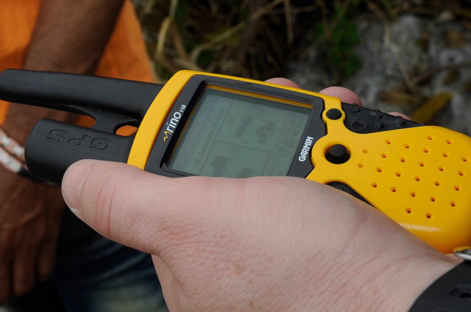 A Catholic youth group member from Kadena Air Base, Japan, checks the coordinates on their hand-held GPS to find a geocache near Araha Beach, March 21, 2015. Geocaching became popular around the year 2000 when GPS became more accurate and accessible to the public. (U.S. Air Force photo by Staff Sgt. Marcus Morris)