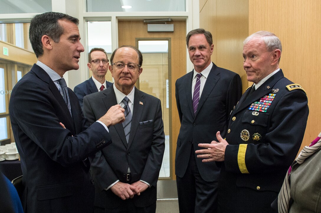 Army Gen. Martin E. Dempsey, chairman of the Joint Chiefs of Staff, talks with Los Angeles Mayor Eric Garcetti, left, and University of Southern California President C.L. Max Nikias, center left, before participating in a forum on local veterans issues at the university in Los Angeles, March 23, 2015.