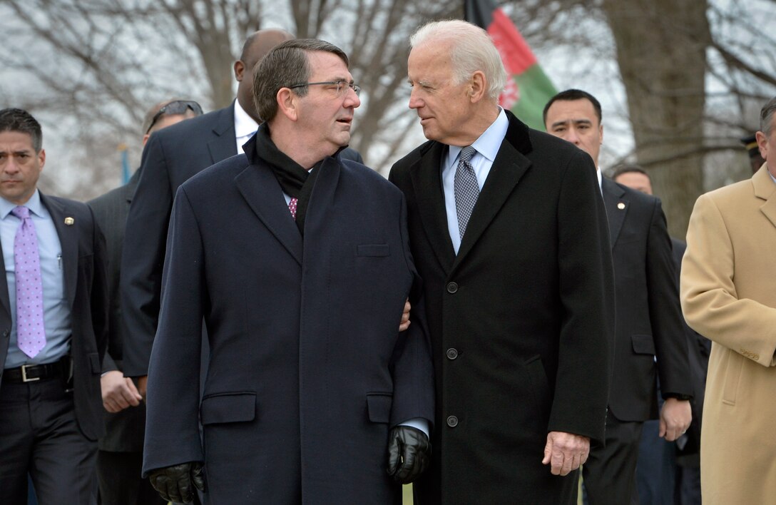 U.S. Defense Secretary Ash Carter, center left, and Vice President Joe Biden talk after a wreath-laying ceremony at Arlington National Cemetery in Arlington, Va., March 24, 2015.