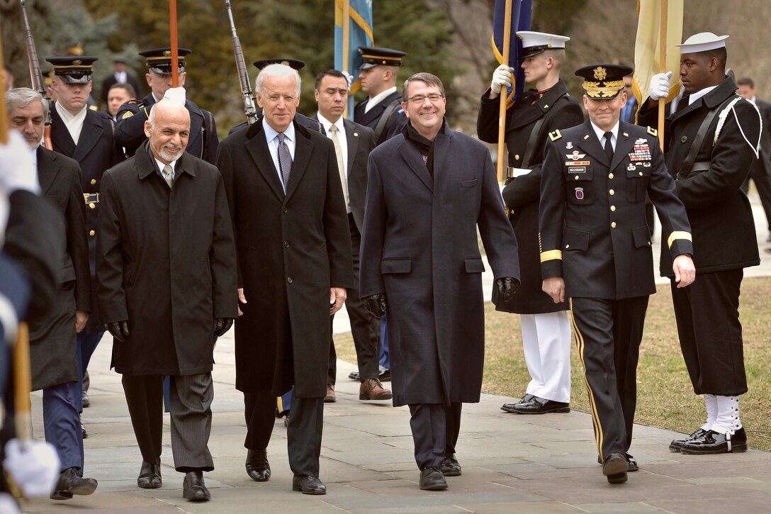 U.S. Defense Secretary Ash Carter, center right, Vice President Joe Biden, center left, and Afghan President Ashraf Ghani, left, walk to the Tomb of the Unknown Soldier before a wreath-laying ceremony at Arlington National Cemetery in Arlington, Va., March 24, 2015.