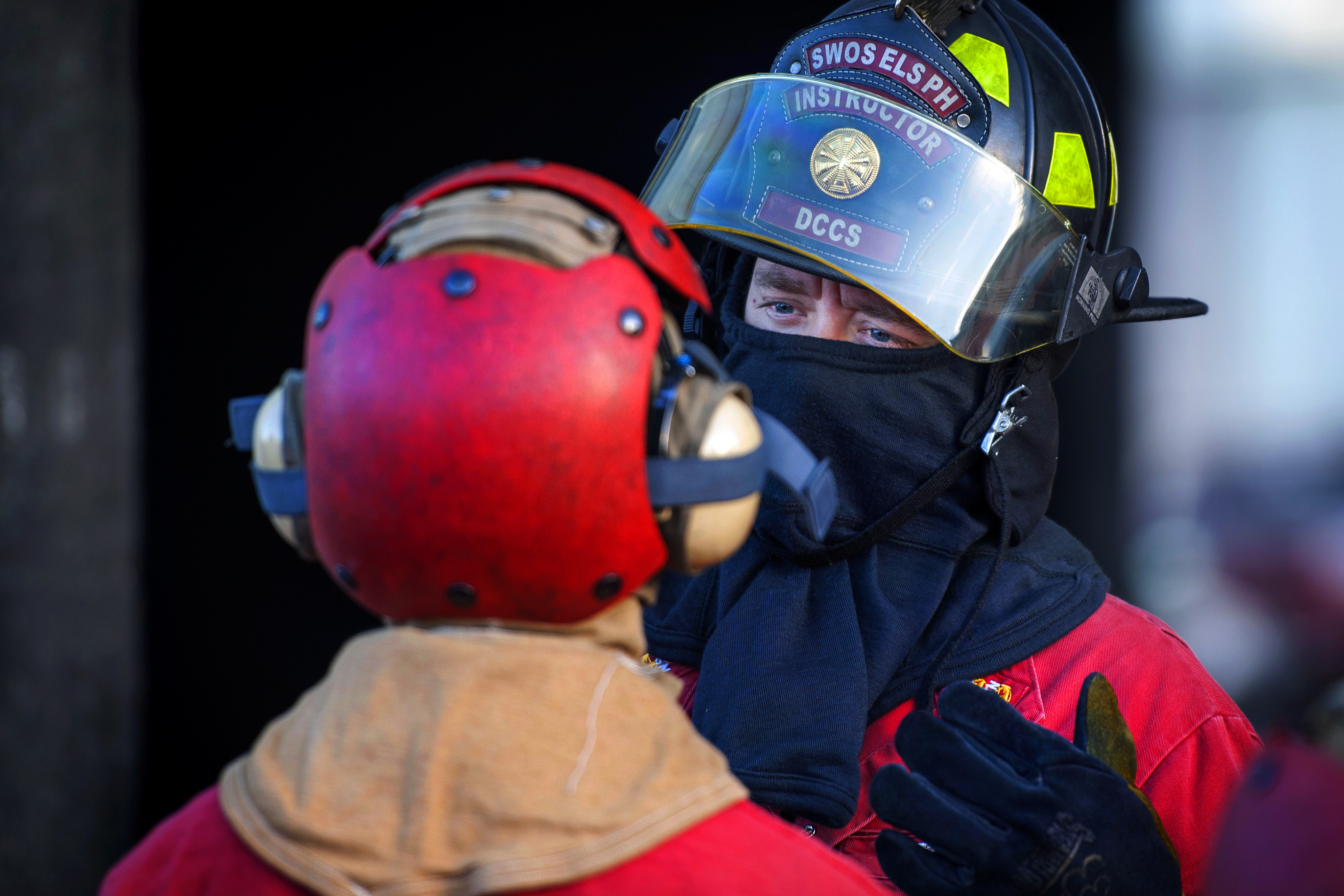 Navy Senior Chief Petty Officer Christopher Salzer briefs a sailor