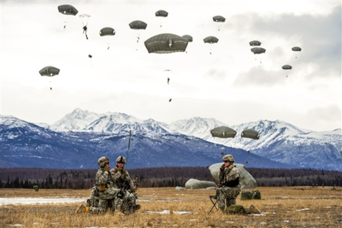 Paratroopers perform radio checks during a practice parachute assault on Malemute drop zone as part of a tactical field exercise on Joint Base Elmendorf-Richardson, Alaska, March 18, 2015. The paratroopers are assigned to the 25th Infantry Division's 4th Infantry Brigade Combat Team, Alaska.