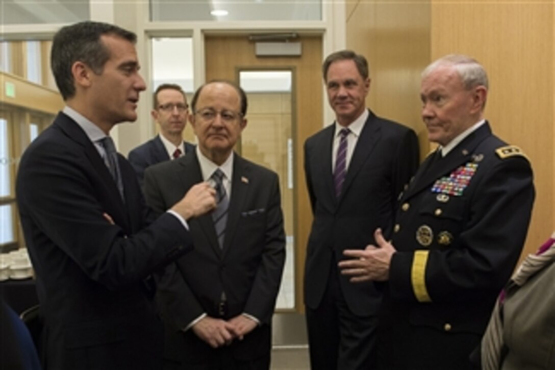 Army Gen. Martin E. Dempsey, chairman of the Joint Chiefs of Staff, talks with Los Angeles Mayor Eric Garcetti, left, and University of Southern California President C.L. Max Nikias, center left, while attending a forum on local veterans issues at the university in Los Angeles, March 23, 2015.
