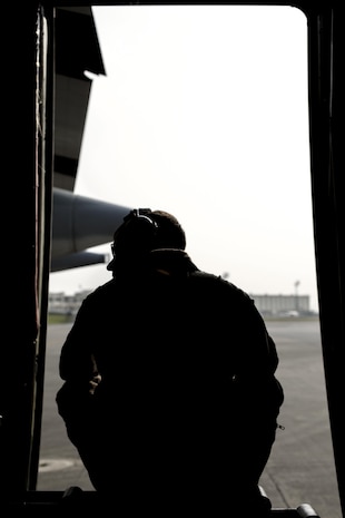 Cpl. Eli Wallace, a crew master with Marine Aerial Refueler Transport Squadron 152, awaits for take-off on a Lockheed KC-130J Hercules on Kadena Air Base, Japan, March 22, 2015. VMGR-152 flew back and forth from Kadena to Iwo To, formally known as Iwo Jima, providing transportation for Marines, VIPs and vehicles. The Reunion of Honor is a ceremony honoring veterans still alive from the battle of Iwo Jima in 1945.