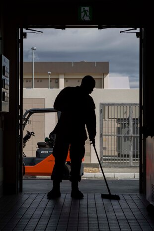 Lance Cpl. Jaquoise Johnson, a food service specialist with Headquarters and Headquarters Squadron, sweeps an exit inside the Flightline Mess Hall aboard Marine Corps Air Station Iwakuni, Japan, March 19, 2015. As part of the ongoing expansion of MCAS Iwakuni, the opening of the new Flightline Mess Hall, slated for April 1, 2015, is part of a plan to improve productivity aboard station.