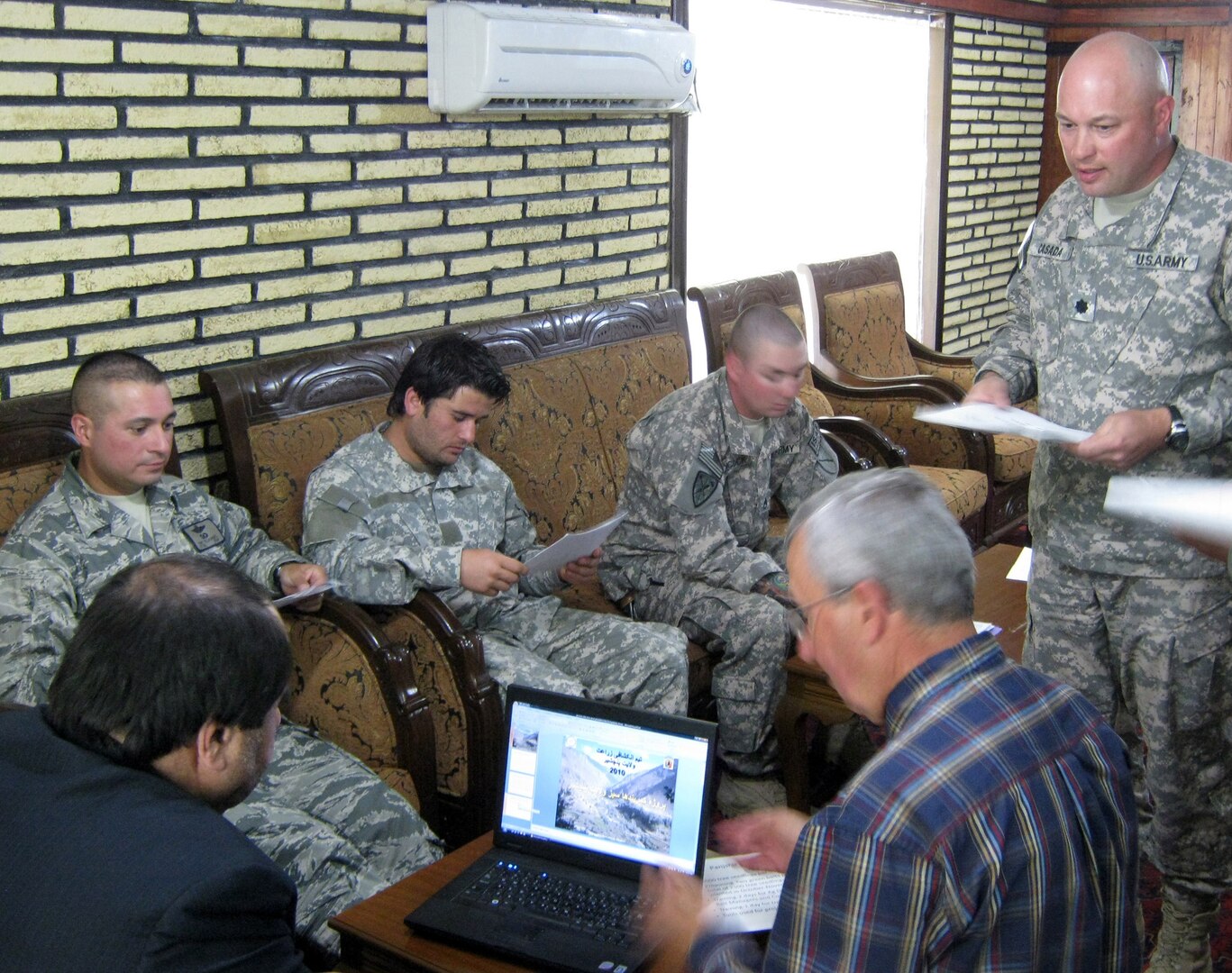 Panjshir Gov. Keramuddin Keram, left, listens to a presentation about the Panjshir Valley Green Belts Project from U.S. Army Lt. Col. Jeffrey Casada, right, Kentucky National Guard Agri-Business Development Team leader with the Panjshir Provincial Reconstruction Team, while Jim Hoffman, U.S. Department of Agriculture advisor to the Panjshir PRT, runs the computer slide show. The July 1, 2010 presentation proposed a project that would bring 35,000 new trees into the province by the end of the year.