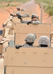 Air Force Staff Sgt. Ryan Deane talks with security forces Airmen during a convoy live fire exercise on a range in New Mexico, June 30, 2010. Deane is assigned as an instructor at the Desert Defender Regional Training Center, which is operated by the Texas Air National Guard's 204th Security Forces Squadron.